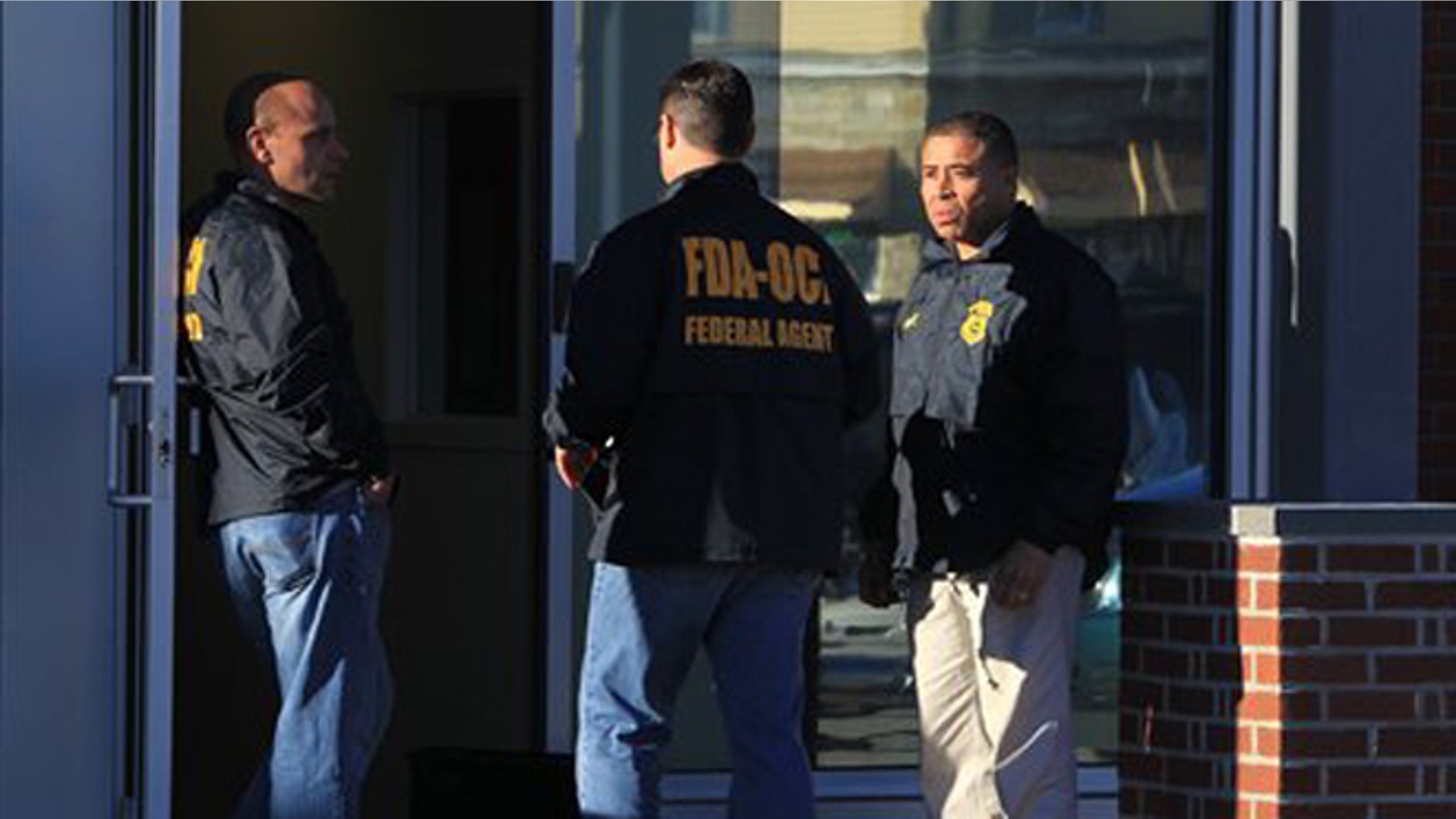 Federal agents investigate the offices of New England Compounding Center in Framingham, Mass., Tuesday, Oct. 16, 2012. The company's steroid medication has been linked to a deadly meningitis outbreak. FDA spokesman Steven Immergut says the visit is part of the investigation into the outbreak, which has killed at least 15 people and sickened more than 200 others in 15 states. (AP Photo/The Boston Globe, Barry Chin) BOSTON HERALD OUT, QUINCY OUT