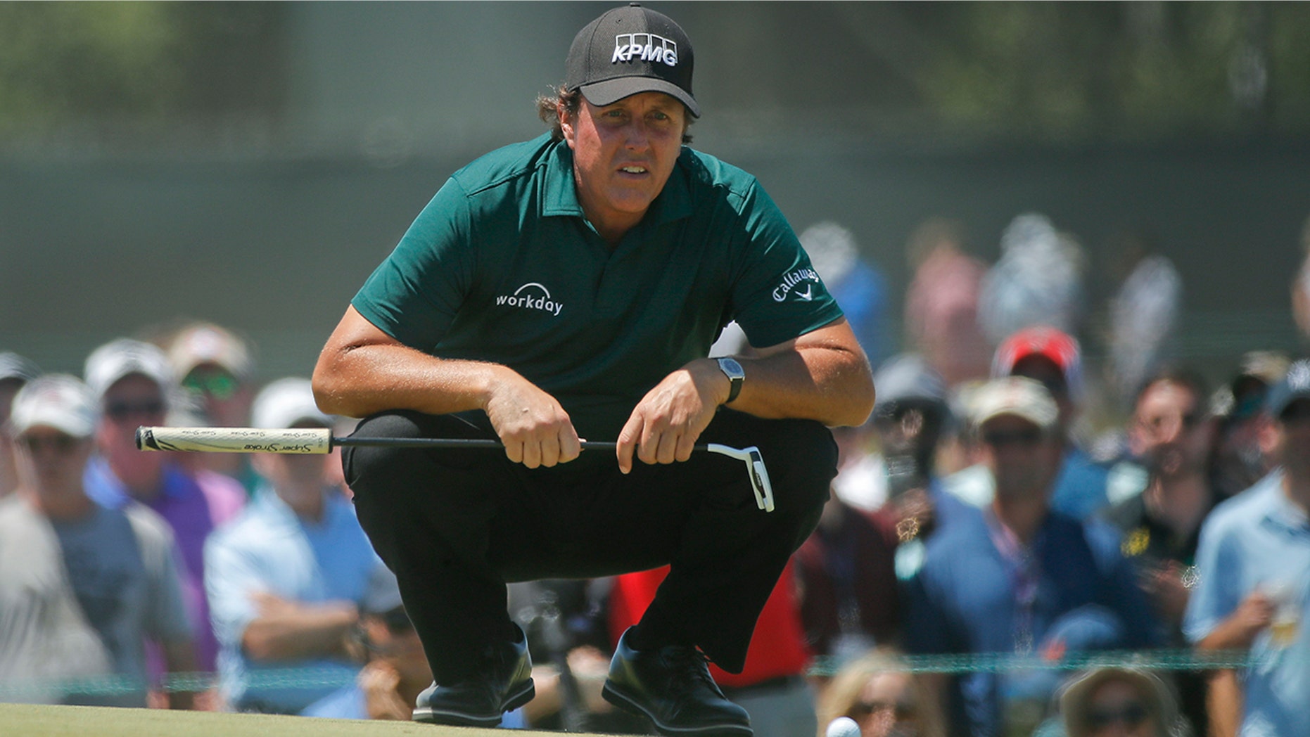 Phil Mickelson lines up a shot on the fourth green during the third round of the U.S. Open Golf Championship, in Southampton, N.Y., June 16, 2018.
