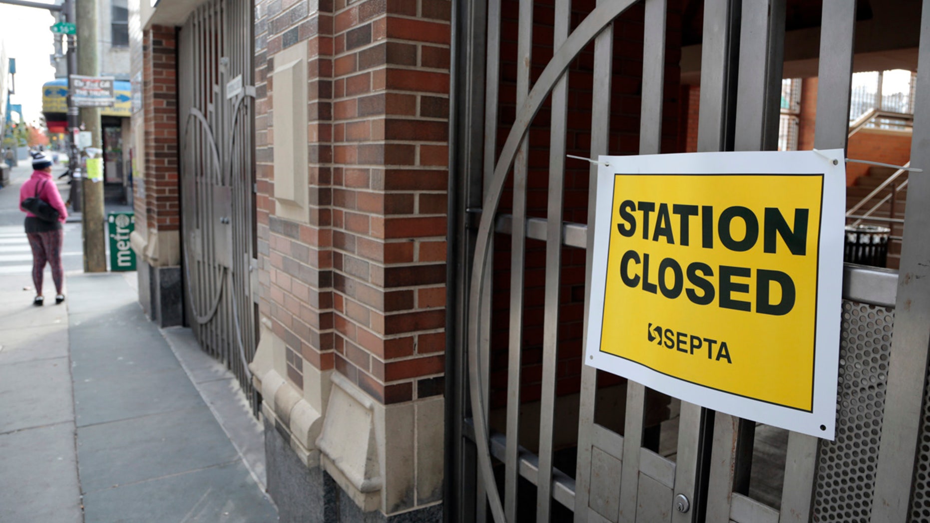 A pedestrian outside a locked rail station in west Philadelphia Tuesday, Nov. 1, 2016.
