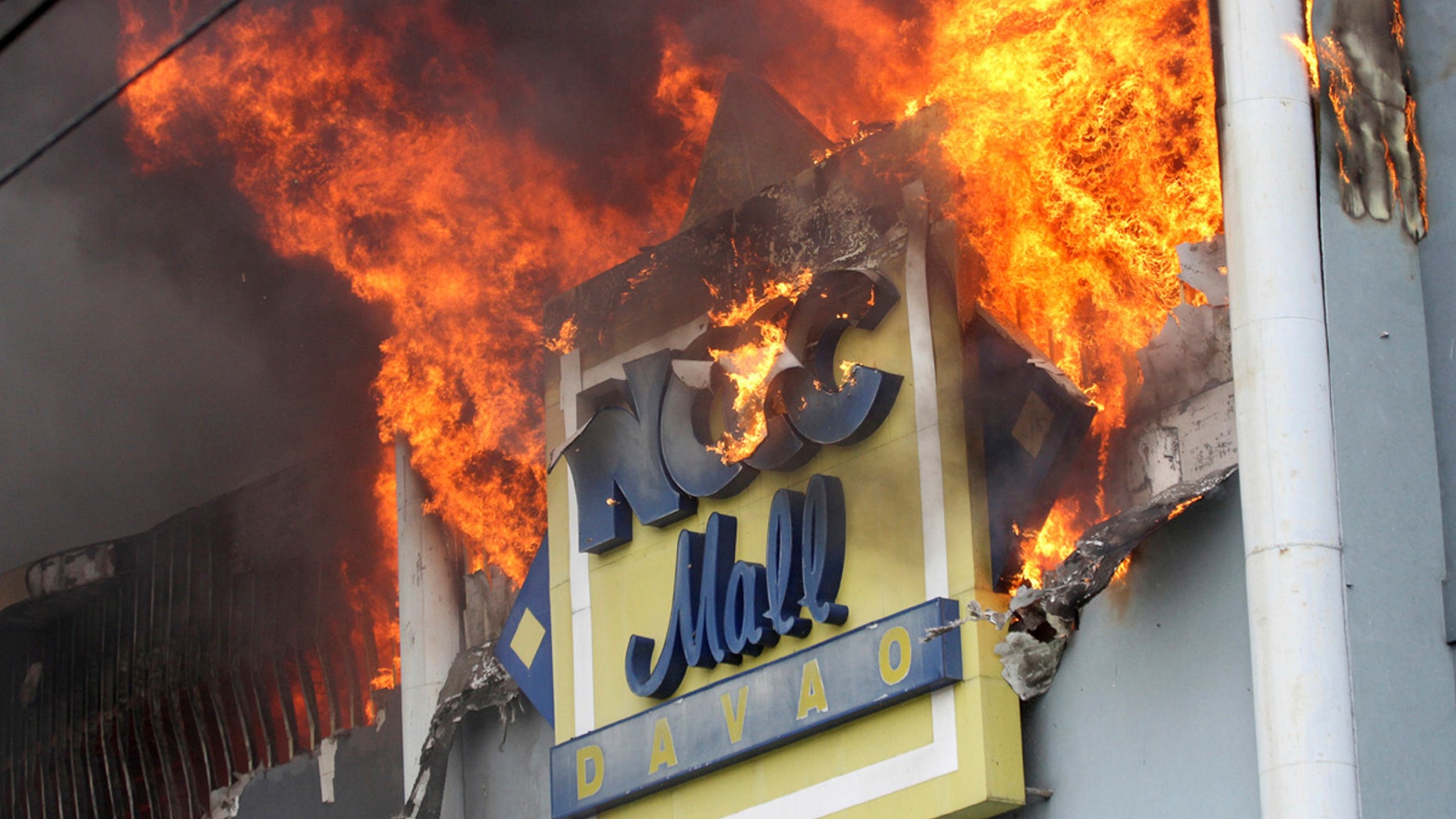 A fire rages on at a shopping mall Saturday, Dec. 23, 2017, Davao city, southern Philippines.