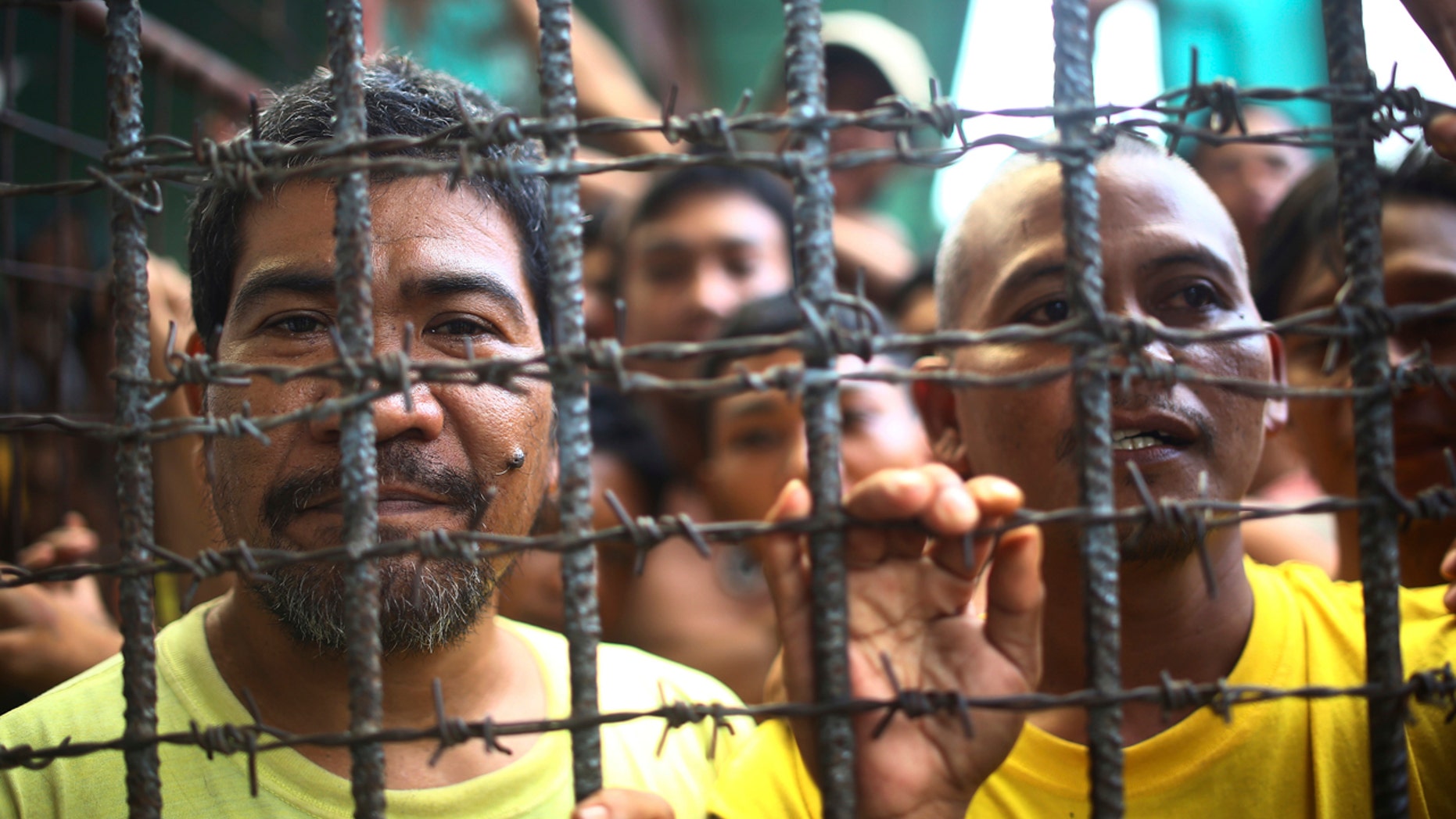 Filipino inmates remain in their cell at the North Cotabato District Jail in Kidapawan city, Cotabato Province, southern Philippines, after a massive jailbreak Wednesday, Jan. 4, 2017.