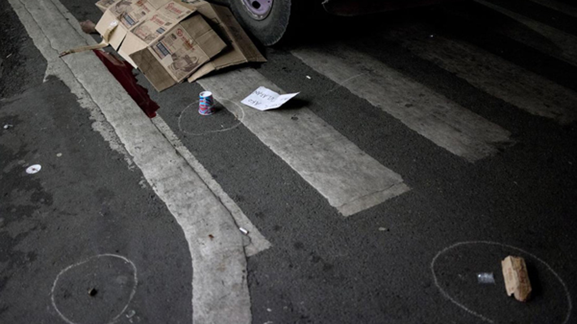A man's body lies covered with cardboard boxes after he was shot dead by unidentified gunmen in front of a convenience store in Manila last October.
