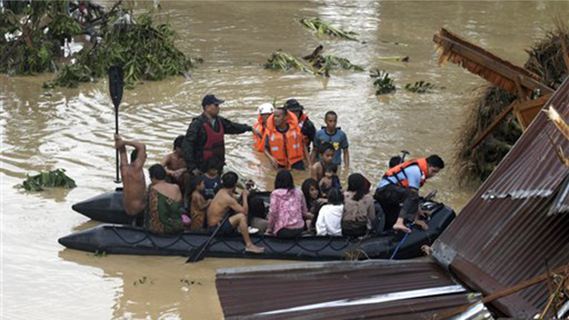 Dec. 17, 2011: Police rescue trapped residents following a flash flood that inundated Cagayan de Oro city, Philippines.