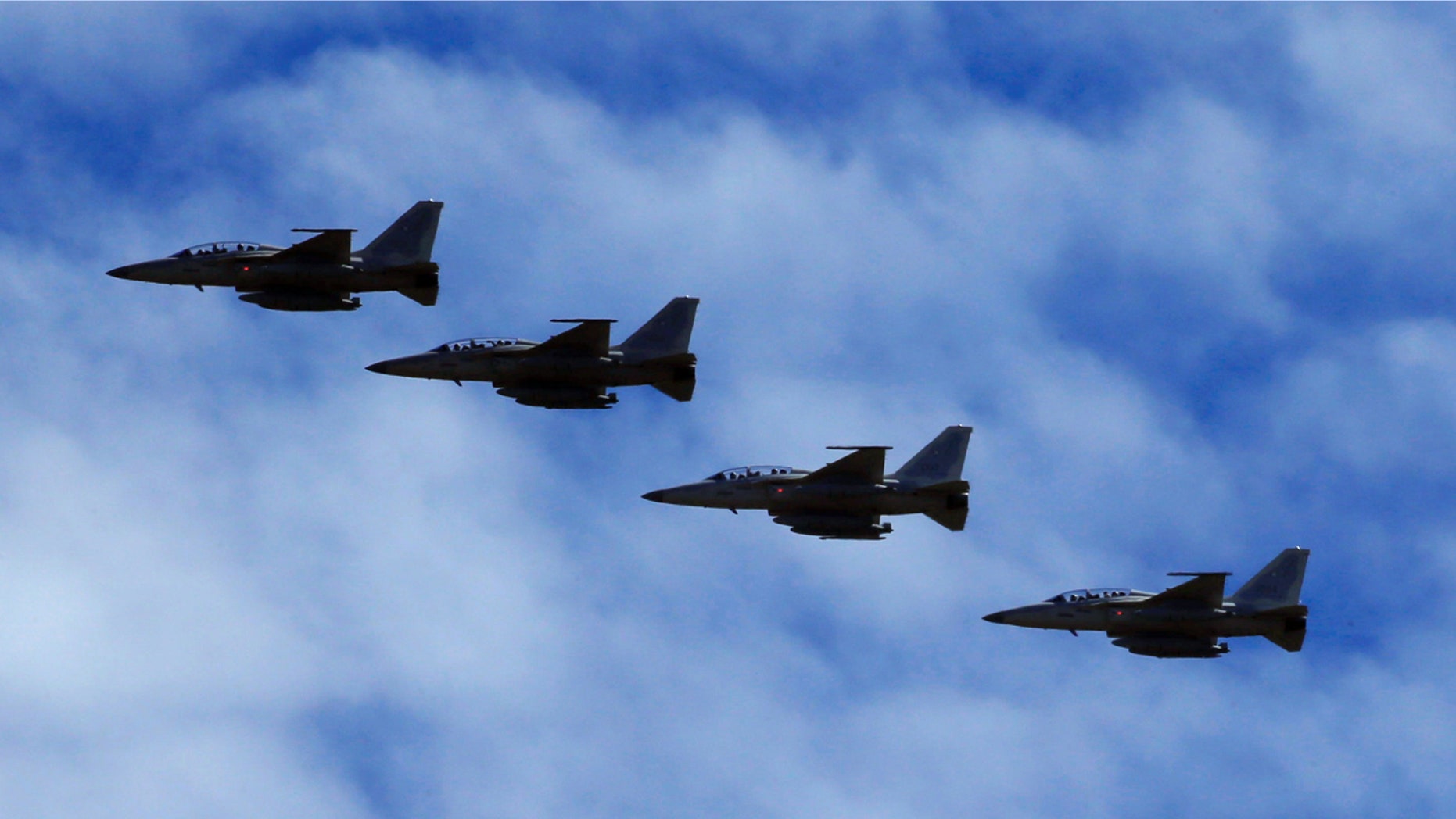 FA-50 fighter jets, newly purchased from South Korea, are escorted by fighter jets in the sky upon arrival in Clark air base, Angeles city, Pampanga province, north of Manila, Philippines December 1, 2016. REUTERS/Romeo Ranoco - RTSU4O9
