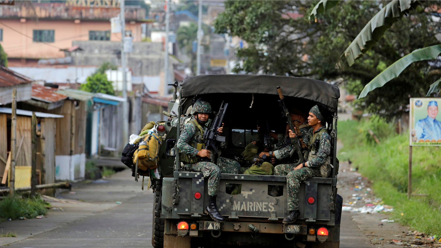Philippine Marines ride in a military vehicle as they advance their position in Marawi City, southern Philippines May 30, 2017. REUTERS/Erik De Castro - RTX3864E