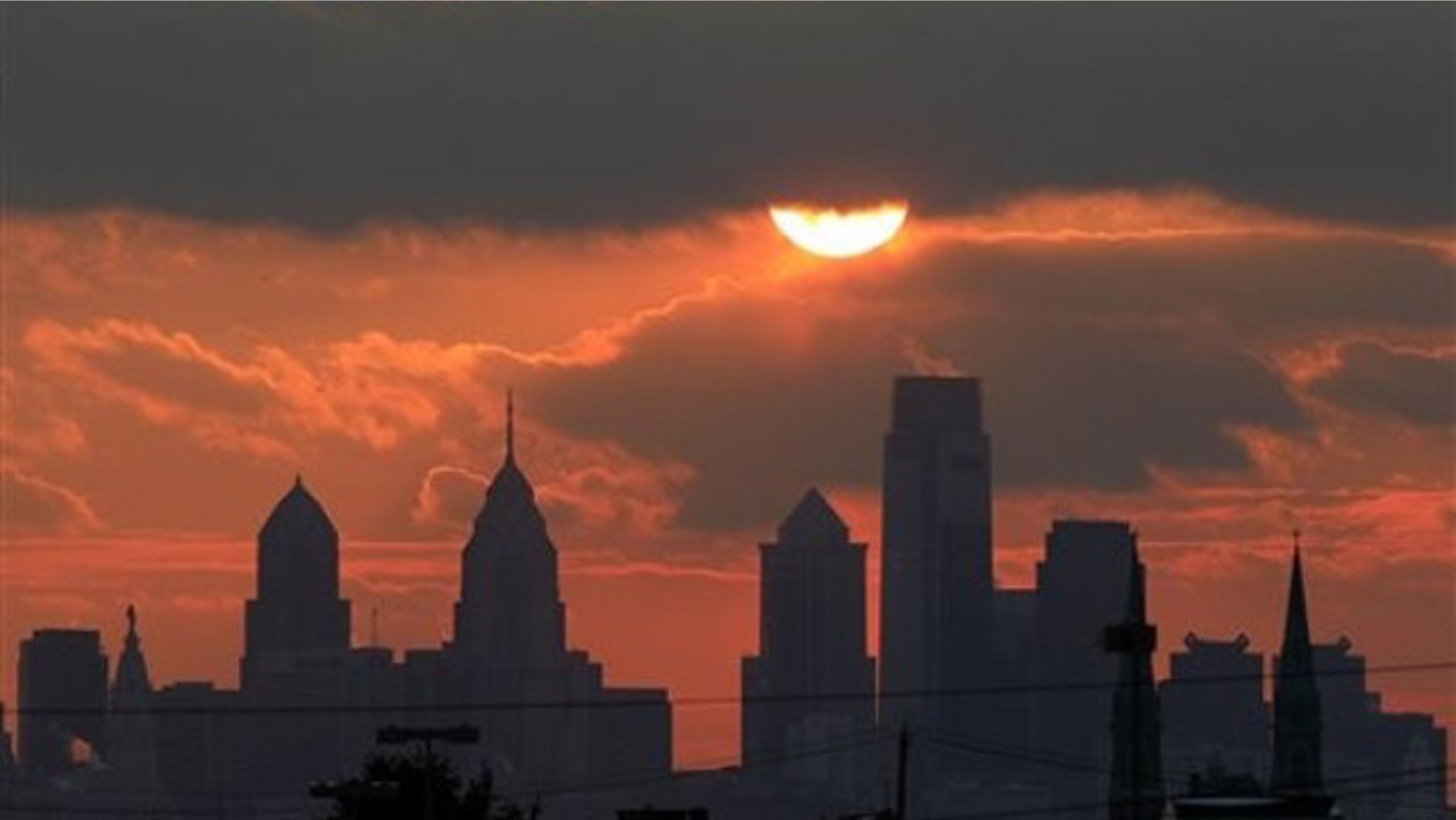 The sun is seen low in the sky before it sets behind the city skyline of Philadelphia on Friday, Jan. 14, 2011.