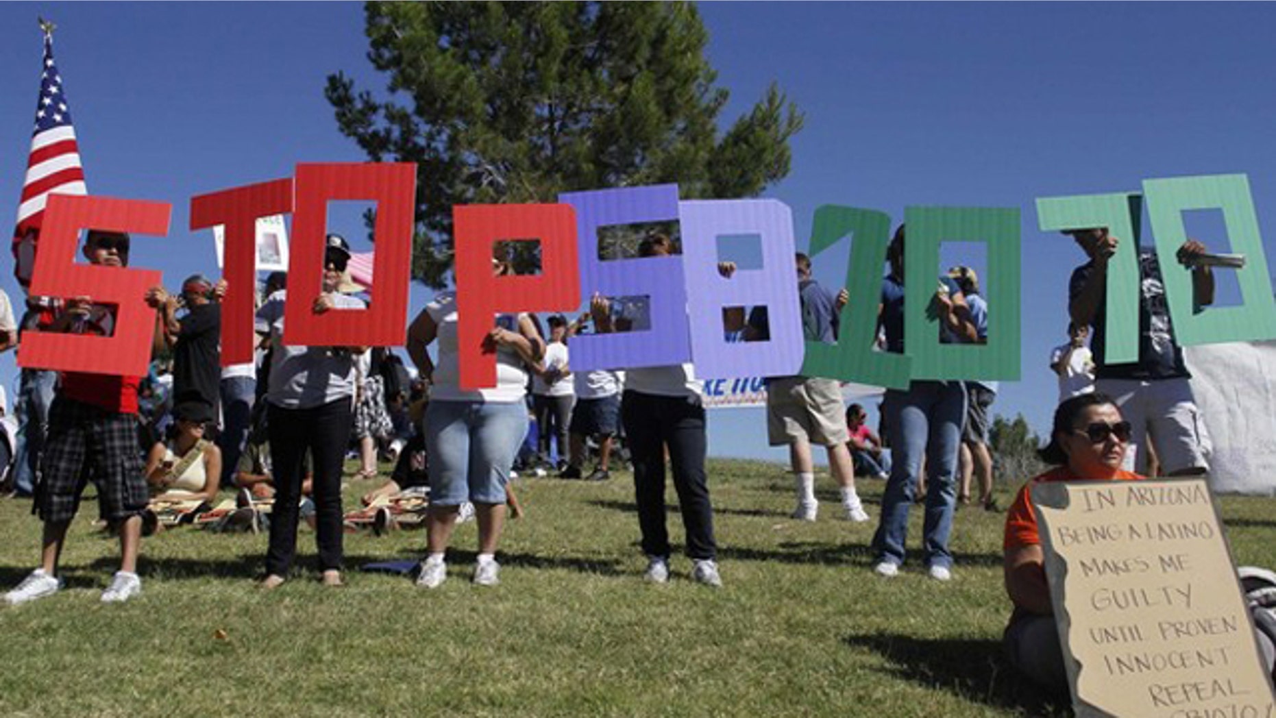 Demonstrators protest against Arizona's immigration law before marching to the State Capitol in Phoenix May 29. (Reuters Photo)