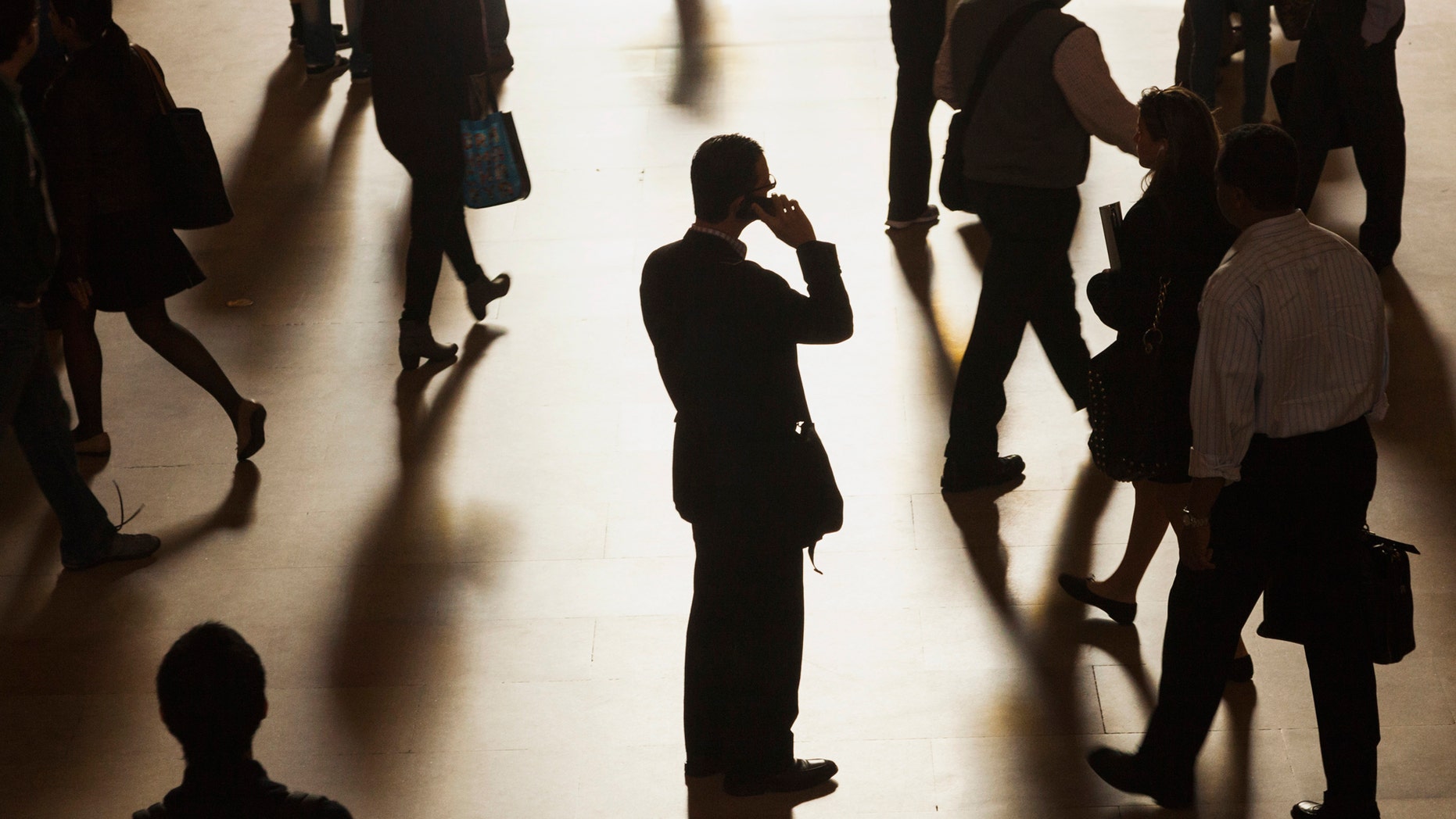 File photo - A man stands in the middle of Grand Central Terminal as he speaks on a cell phone.