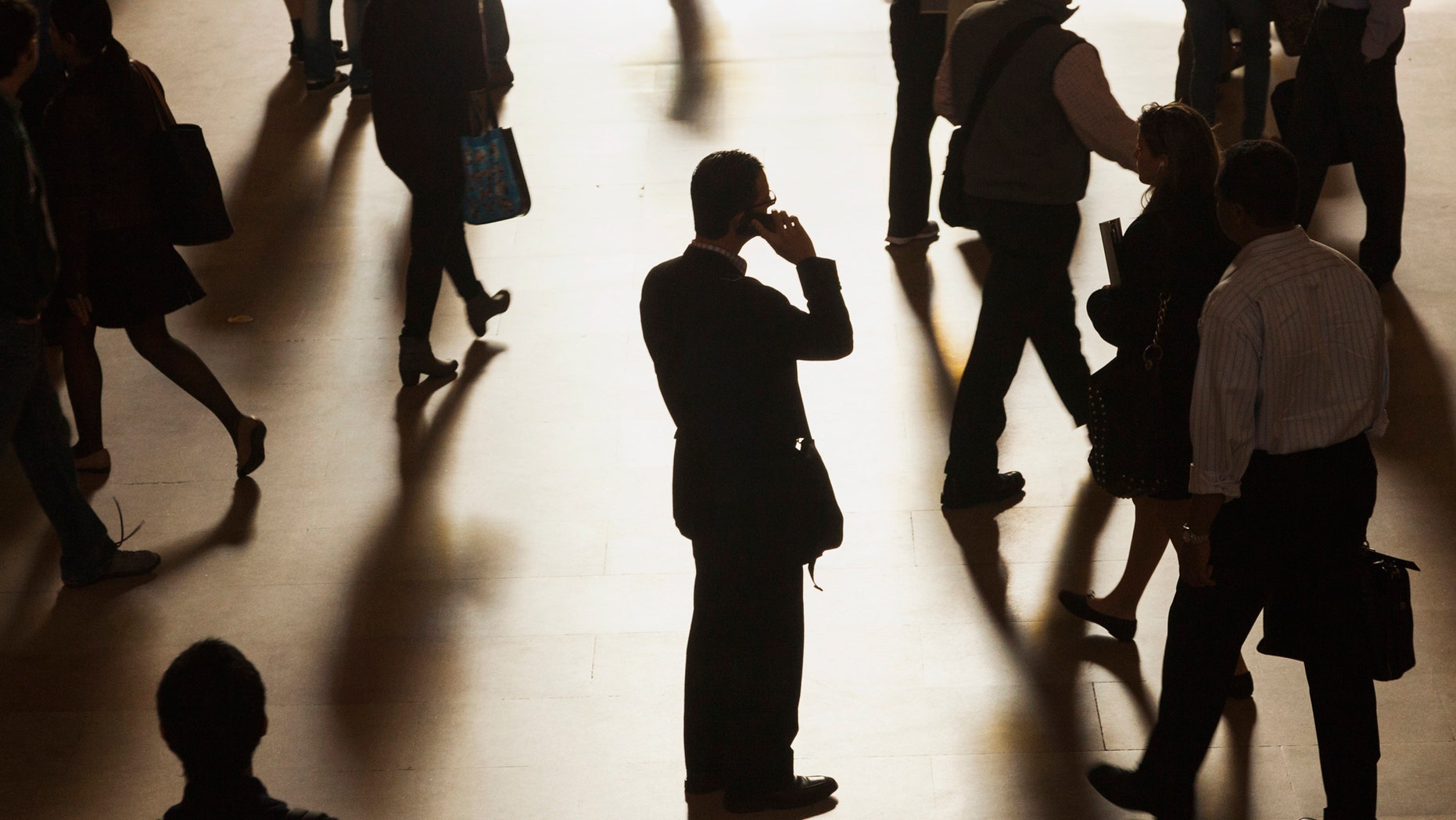 File photo - A man stands in the middle of Grand Central Terminal as he speaks on a cell phone.