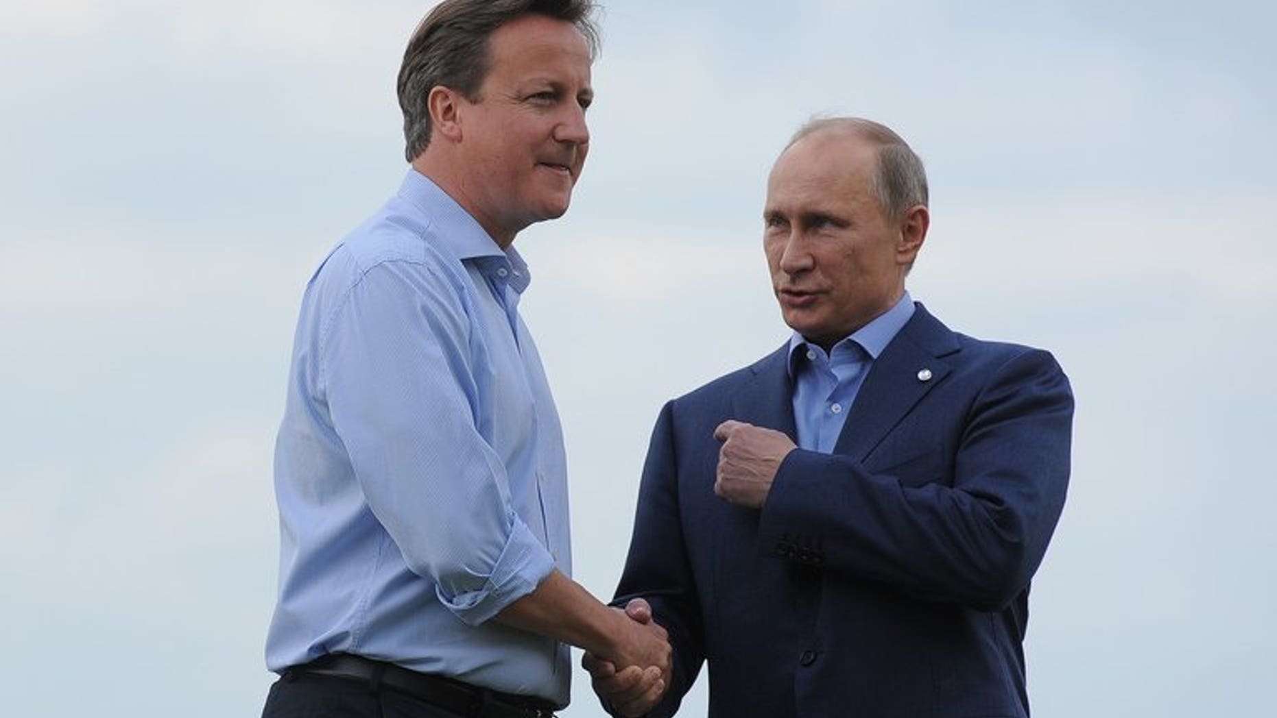 British Prime Minister David Cameron (L) greets Russia's President Vladimir Putin during the official arrrivals for the start of the G8 Summit at the Lough Erne resort near Enniskillen in Northern Ireland on June 17, 2013. UK officials said Russia risks isolation from the West if it does not sign up to action in Syria.