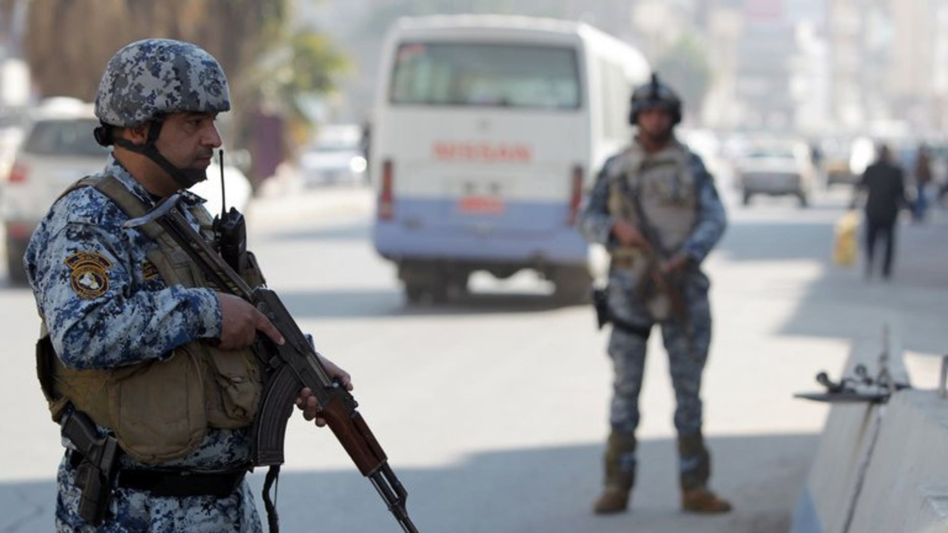 Iraqi policemen stand at a checkpoint in central Baghdad on November 29, 2012. A suicide bomber blew himself up on Tuesday at a Shiite Muslim religious hall in north Baghdad, killing at least 15 people, security officials said, the latest in a surge in nationwide violence.