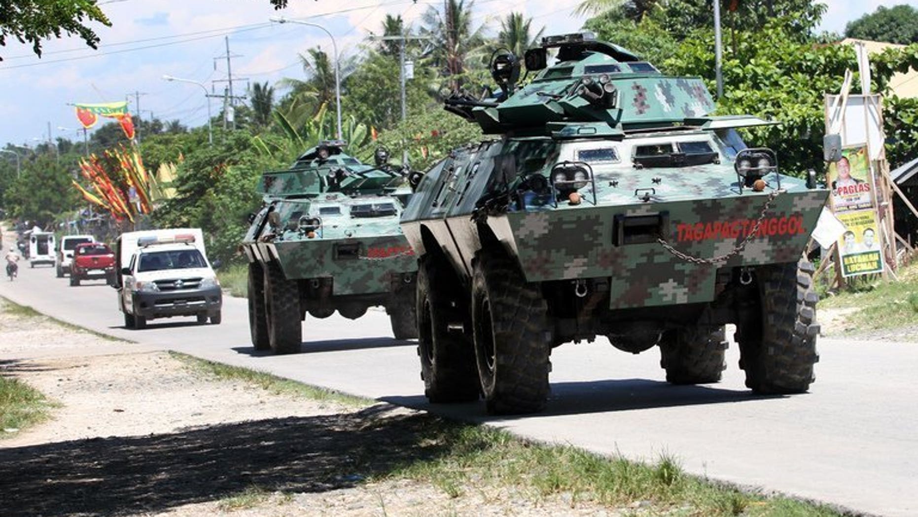 File picture taken on May 13, 2013 shows armored vehicles patrolling a highway on the southern Philippine island of Mindanao. Communist insurgents killed five civilians and kidnapped five soldiers on Mindanao on Tuesday in the latest of a series of violent acts following the collapse of peace talks, authorities said.