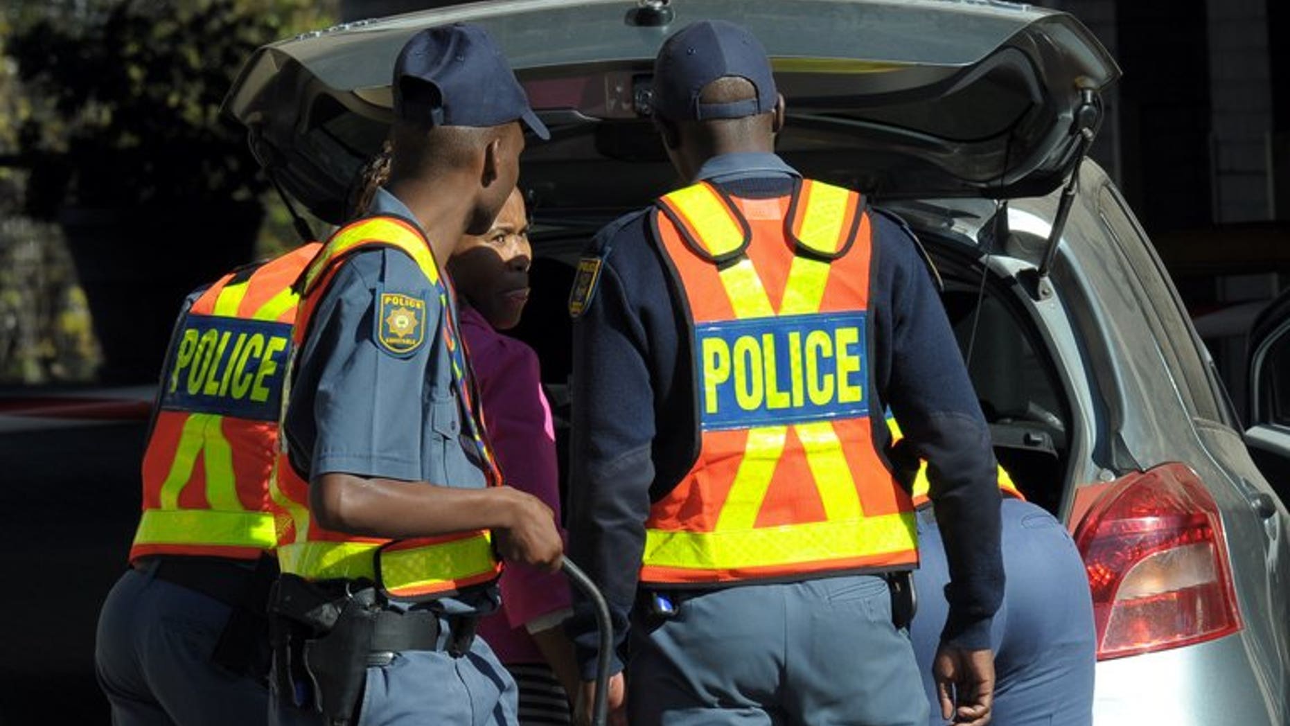 Police check people arriving at the Medi-Clinic Heart Hospital in Pretoria, last week. A South African police commander was found murdered in a field with his hands and feet bound in the early hours of Tuesday, a police commissioner said.