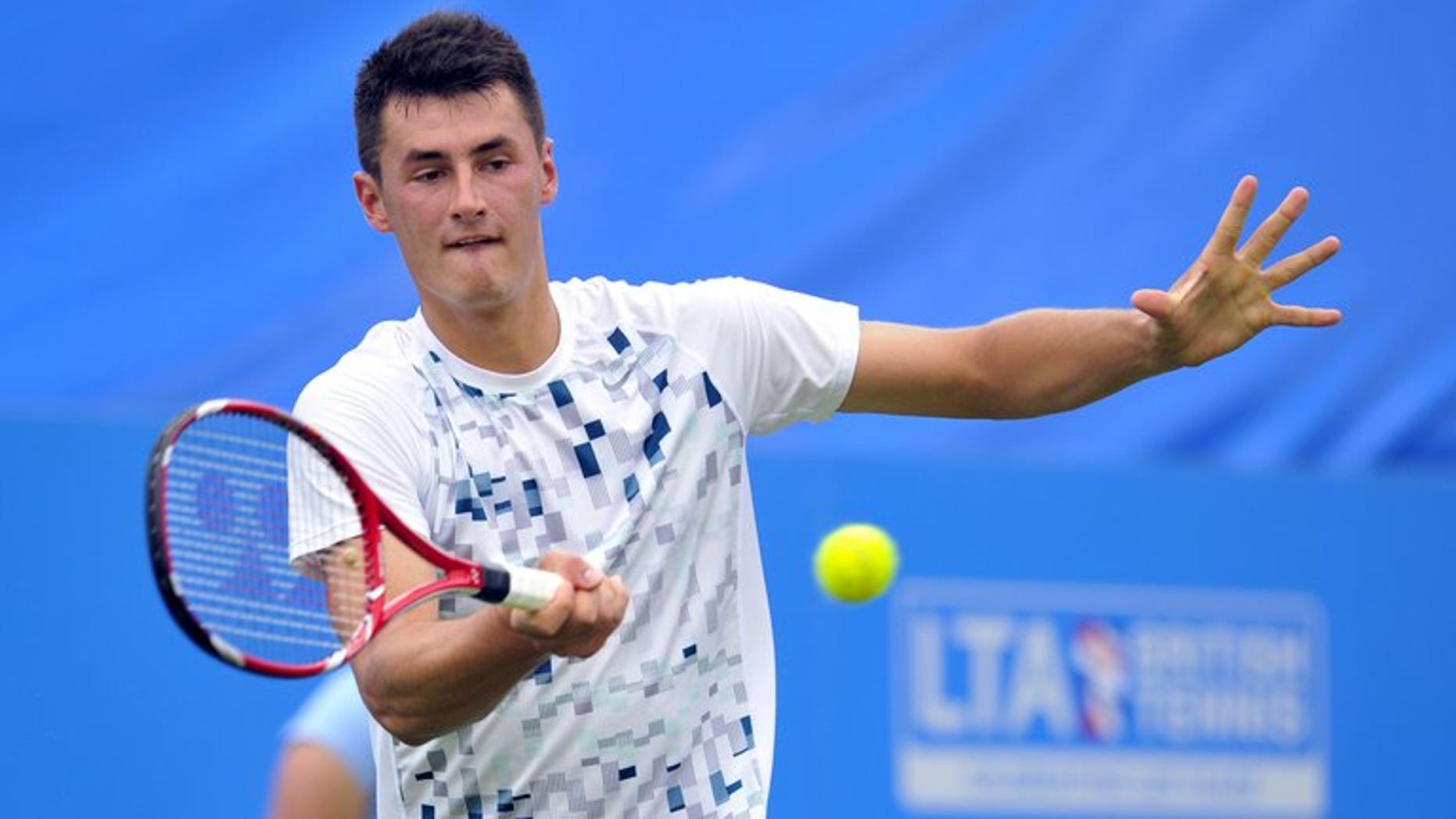 Australia???s Bernard Tomic plays against Britain???s James Ward during the AEGON International tennis tournament in Eastbourne on June 18, 2013. Tomic has recharged his form on grass, shaking off last week's hamstring concern to post a 6-3, 6-4 first round win over Ward at the ATP-WTA Eastbourne International.
