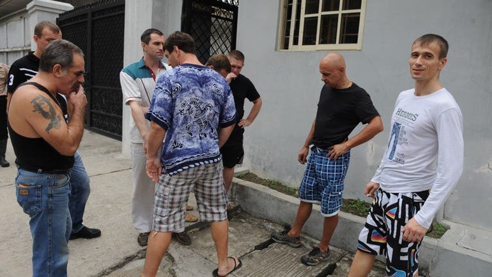 Russian sailors outside a Lagos courthouse on Tuesday during a hearing on claims of illegal possession of arms. The courtdismissed charges against eight of 15 Russian seamen arrested in October, but set a trial date for later this week for the others.