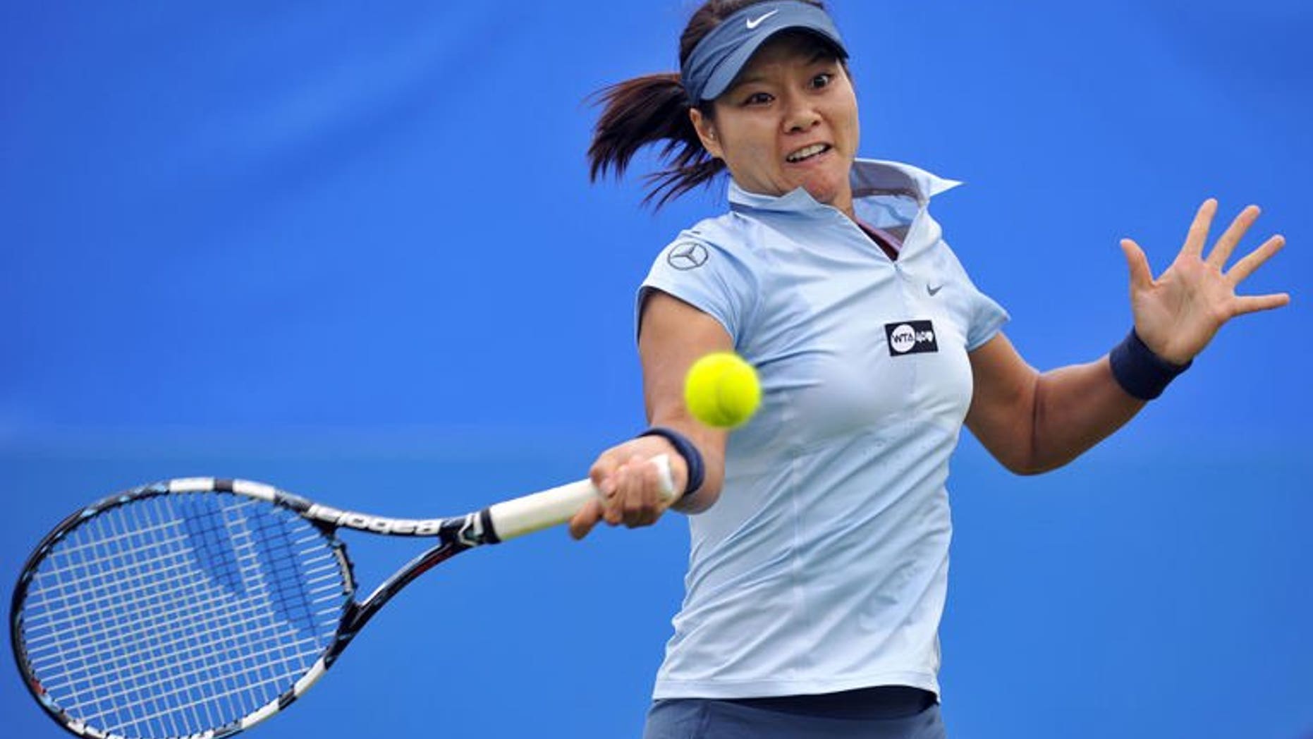 China's Li Na hits a return during her women's singles match against France's Alize Cornet on the fourth day of the AEGON International tennis tournament in Eastbourne, southern England on June 18, 2013. Li won 6-2, 6-4.