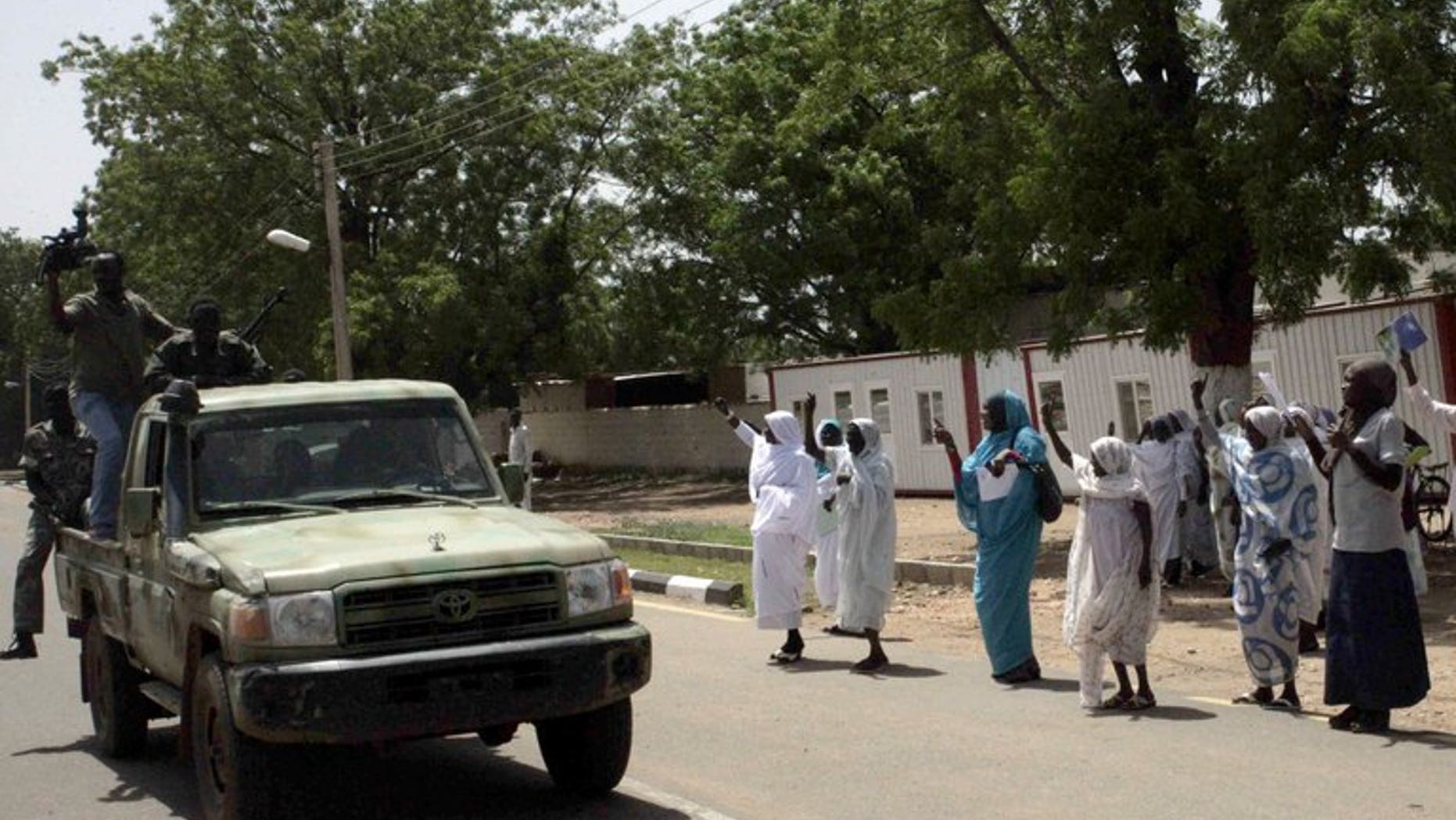 Security forces patrol as Sudanese people take part in celebrations ahead of the CECAFA Kagame Club Cup in Kadugli, South Kordofan, on June 17, 2013. Suspected rebel shell-fire hit Kadugli on Tuesday, the opening day of the African regional football tournament, local sources said.