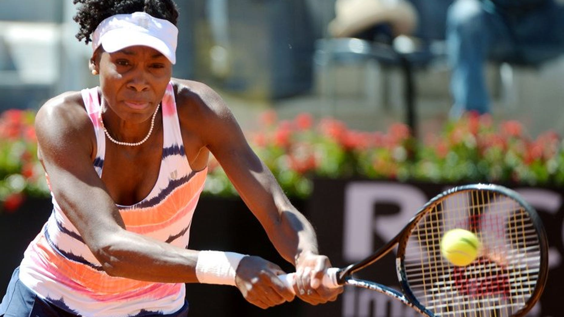Venus Williams of the United States returns a forehand to Australian Laura Robson during the WTA Italian Open in Rome on May 13, 2013. Venus has pulled out of this year's Wimbledon tournament because of an ongoing lower back injury.
