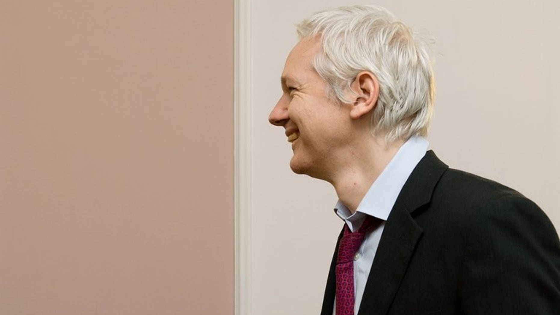 Wikileaks founder Julian Assange arrives for a photocall with French politician Jean Luc Melenchon inside the Ecuadorian embassy in central London, on December 6, 2012. A year after seeking refuge at the Ecuadorian embassy in London, Assange remains fearful of US "revenge" over the WikiLeaks disclosures and aware that the diplomatic deadlock over his case may continue for months, if not years.