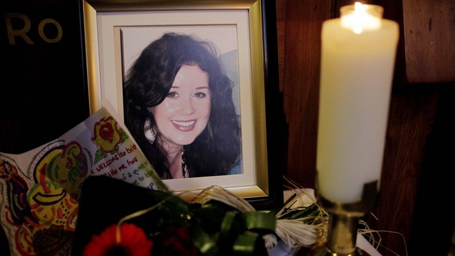 A candle burns next to portrait of Jill Meagher during a memorial mass at St.Peters Catholic church in Drogheda, Ireland, on October 5, 2012. A serial sex offender was on Wednesday sentenced to life for the "savage" rape and murder of Meagher (an Irish) in a Melbourne street, a random killing which shocked Australia and led to an outpouring of emotion.