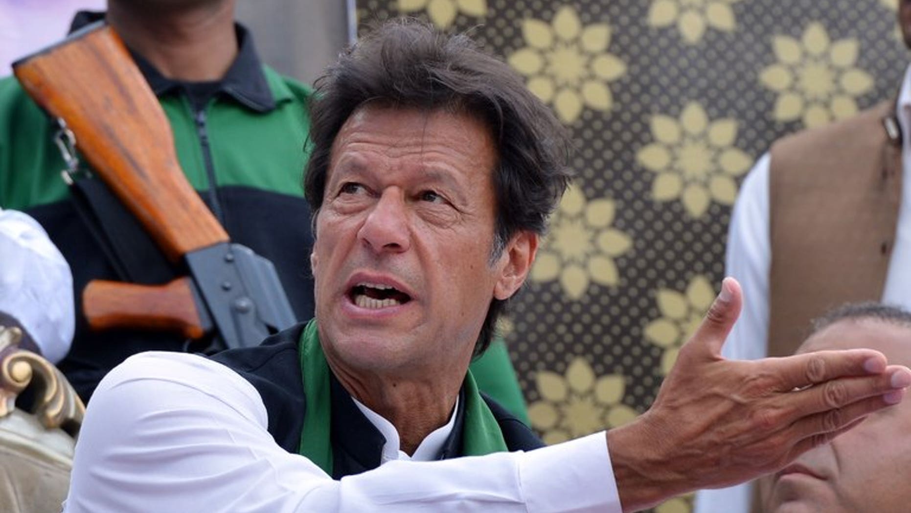 Cricket legend and chairman of Pakistan Tehreek-e-Insaaf (PTI) Imran Khan gestures as he attends a general election campaign meeting in Murree on April 29, 2013. Khan urged the government and military leaders to build a strategy to halt US drone attacks in the country's northwest as he was sworn into parliament.