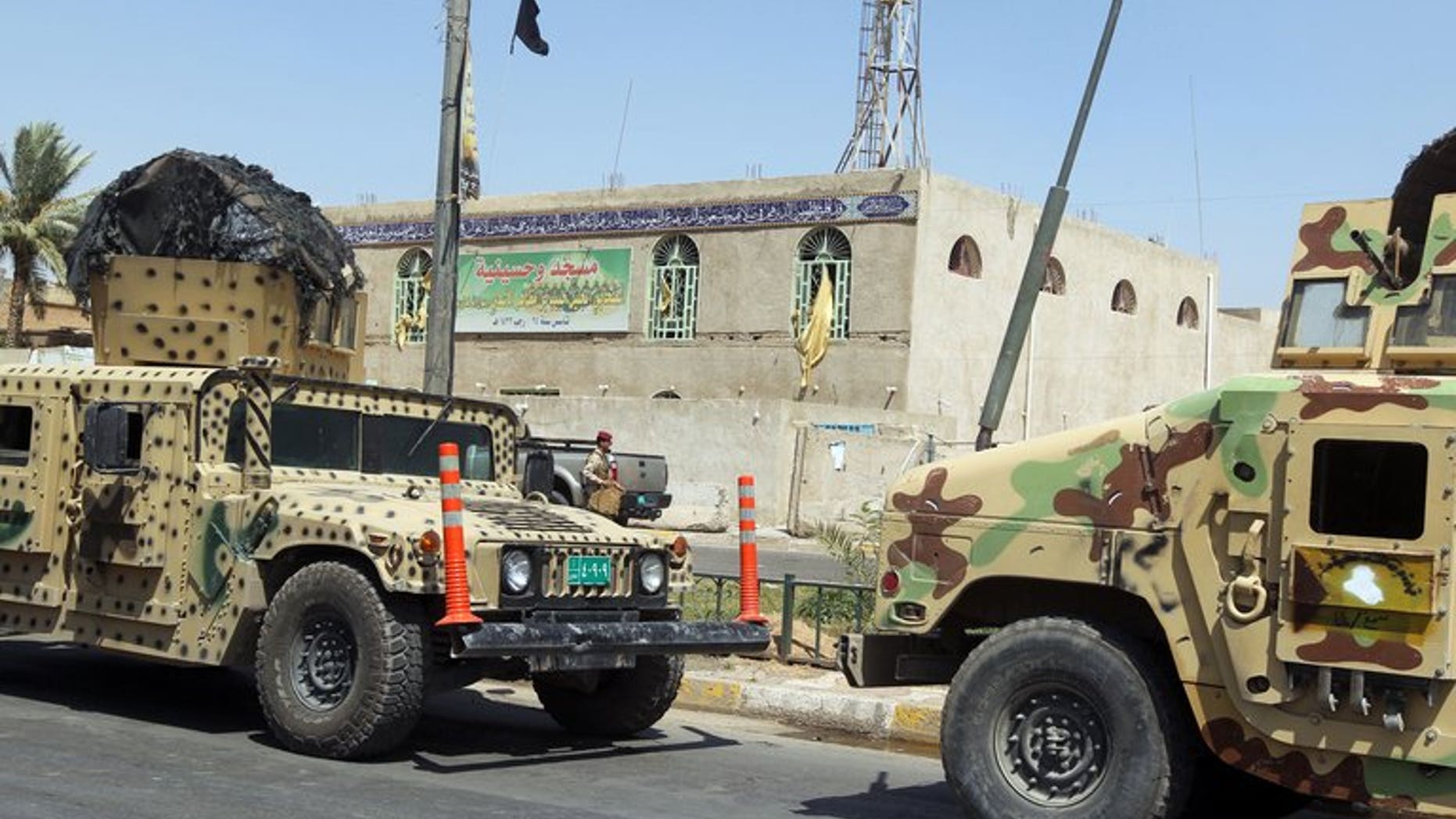 Iraqi military vehicles in front of a Shiite mosque in Baghdad on Tuesday following a suicide bombing. A suicide bomb attack in north Iraq on Wednesday killed the leader of a local political party and four relatives, officials said, on the eve of provincial elections his bloc was to participate in.