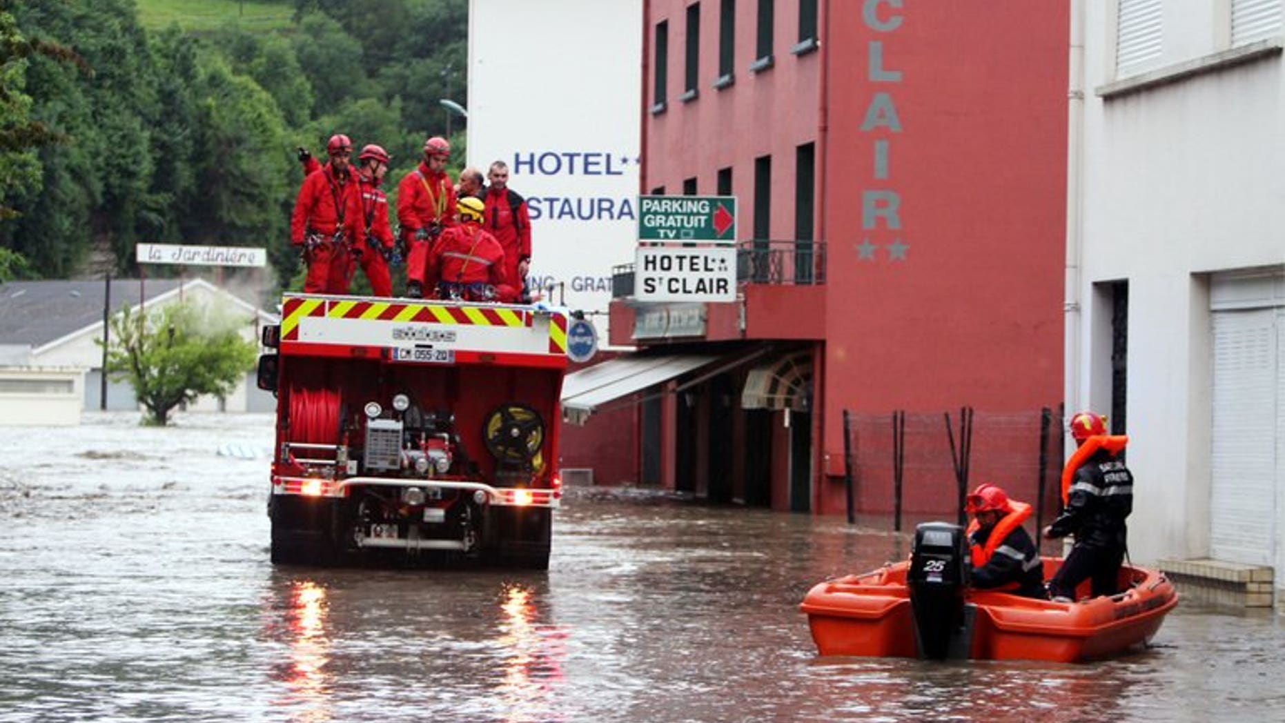 Firemen are at work in Lourdes where the Gave de Pau, the river passing through the town, flooded some pilgrimage areas on June 18, 2013. Flash floods in southwestern France killed an elderly woman as the inundated grotto at the Roman Catholic pilgrimage site of Lourdes remained closed for a second day