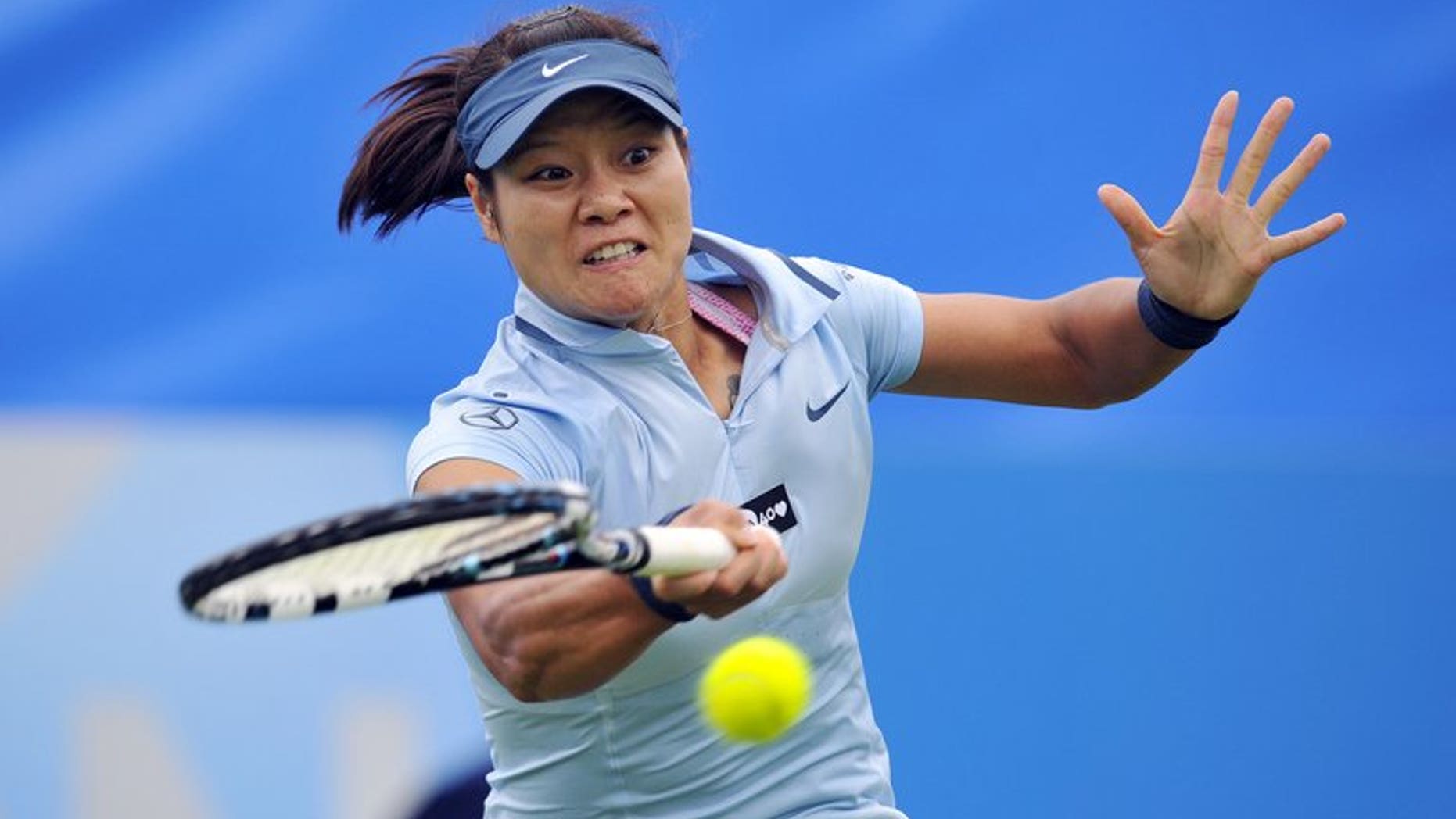 Li Na hits a return against Alize Cornet in Eastbourne, southern England on Tuesday. Li reached the quarter-finals on Wednesday without hitting a ball after scheduled opponent Mario Bartoli pulled out with a virus.