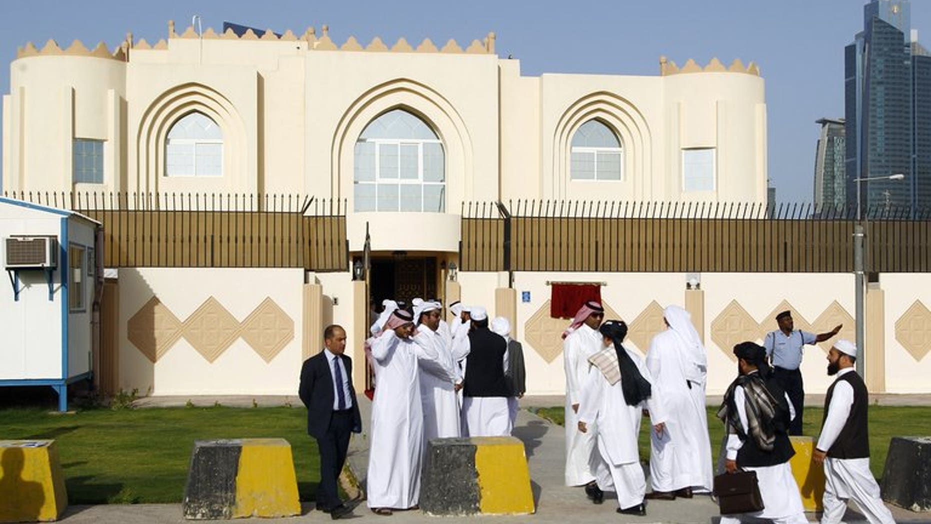 Guests arrive for the opening ceremony of the new Taliban political office in Doha on June 18, 2013. The Taliban office opened in Doha to facilitate peace talks does not carry the name of the "Islamic Emirate of Afghanistan," as it appeared earlier, Qatar said on Wednesday.