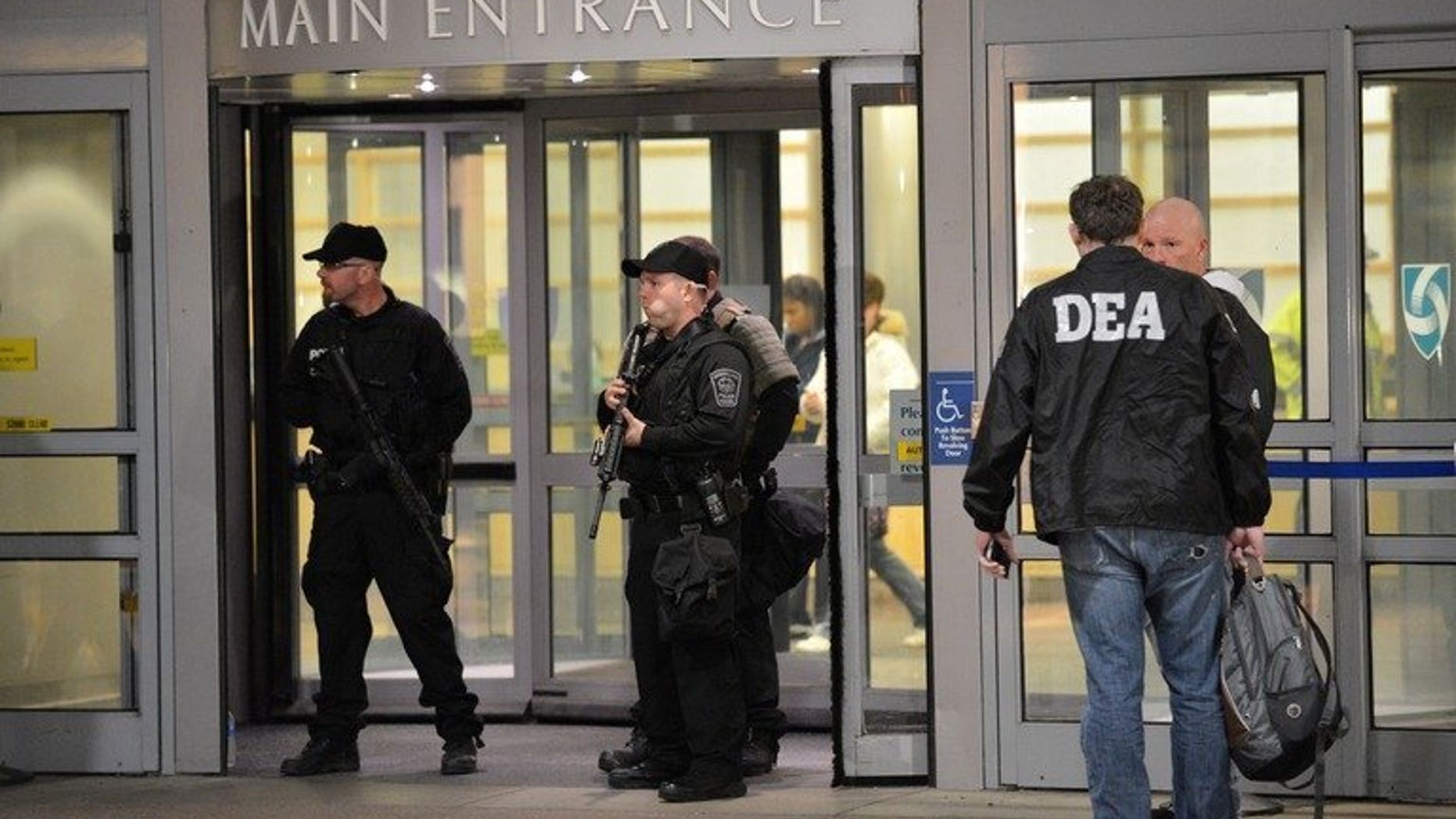 Armed police and Drug Enforcement Agency (DEA) agents in Boston, Massachusetts, April 15, 2013. An agent of the US Drug Enforcement Administration was stabbed to death Friday in Bogota while fighting off an apparent kidnapping attempt, Colombian police and the US embassy said.