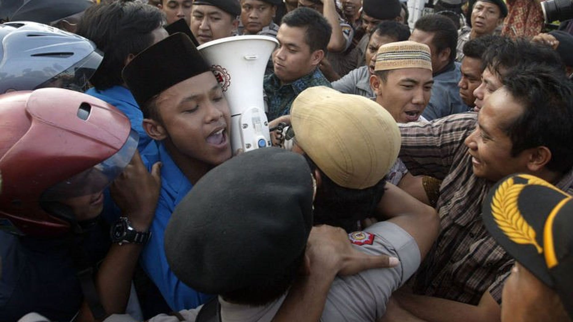 Demonstrators tussle with police during a protest against the impending oil price increase in Surabaya city in eastern Java island on June 21, 2013. Indonesia on Friday announced the first hike in fuel prices since 2008 despite violent protests against the unpopular measure, as Southeast Asia's top economy seeks to reduce crippling subsidies.