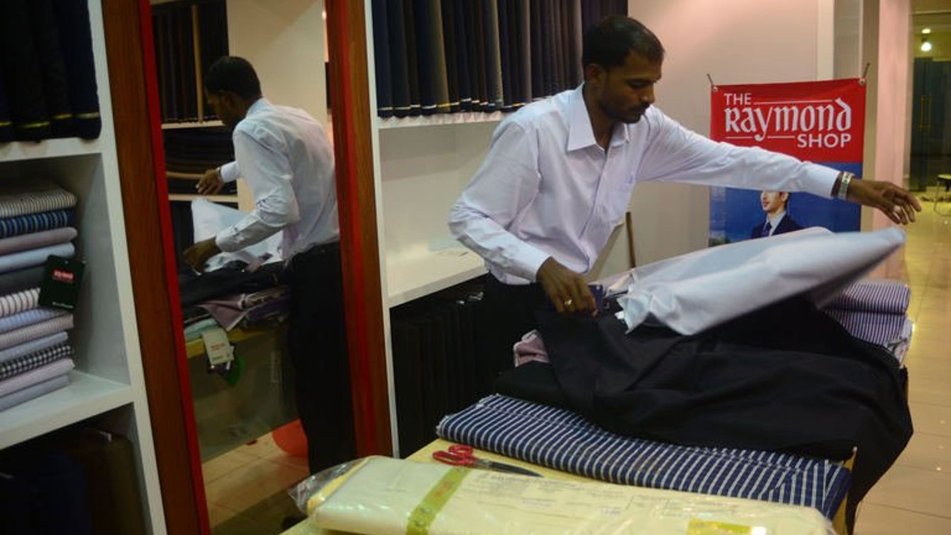 A Pakistani employee works at The Raymond Shop, the first to open in Pakistan, in Karachi on June 21, 2013.