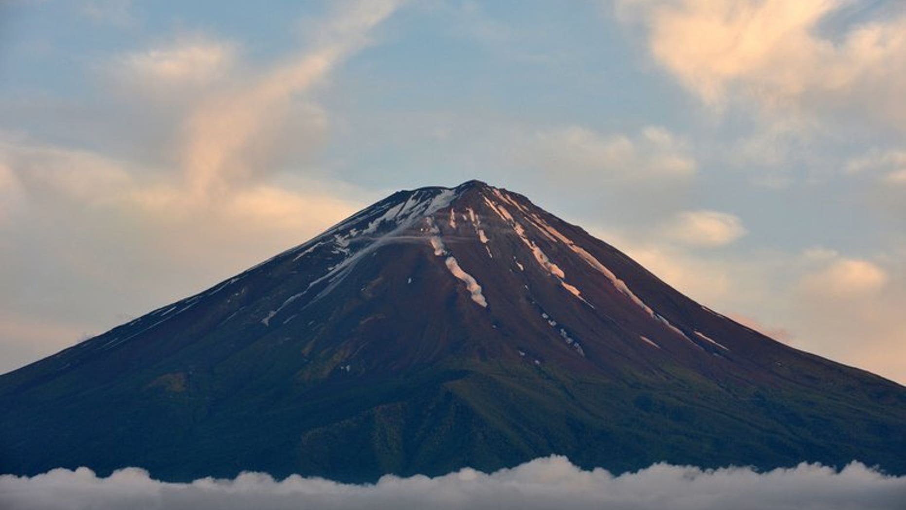 This picture taken on June 16, 2013 shows Mount Fuji, the highest mountain in Japan at 3,776 metres (12,460 feet) in Fujikawaguchiko. UNESCO confirms that Mount Fuji -- known for its perfectly cone-shaped volcano -- has been granted World Heritage status.