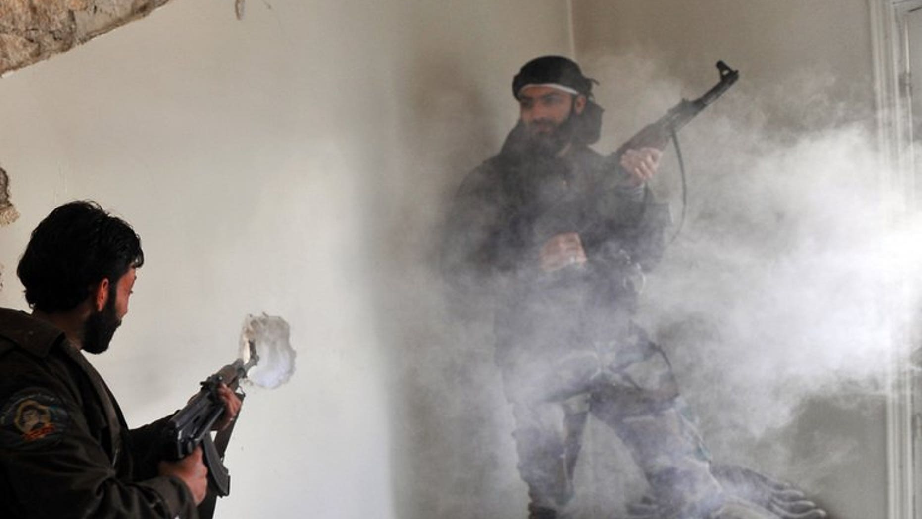 Syrian rebels clash with pro-regime forces in the Saif al-Dawla district of Aleppo on March 23, 2013. British Foreign Secretary William Hague has said his government had taken "no decision" to provide arms to Syrian rebels, ahead of a "Friends of Syria" meeting expected to discuss military aid.