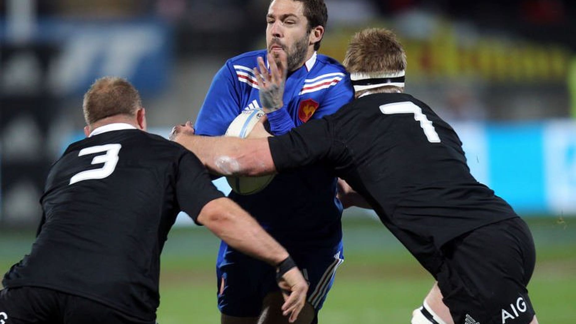 Remi Tales of France (centre) is tackled by Sam Cane (left) and Owen Franks (right) of New Zealand during the third France vs New Zealand rugby union Test match, in New Plymouth on June 21, 2013. The All Blacks beat France 24-9.