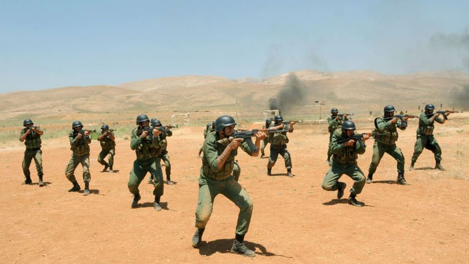 Syrian government soldiers take part in a training exercise at an undisclosed training camp in Syria on may 22, 2013. US Secretary of State John Kerry says supporters of the Syrian opposition will step up military and other aid in a bid to end an "imbalance" on the ground in President Bashar al-Assad's favour.