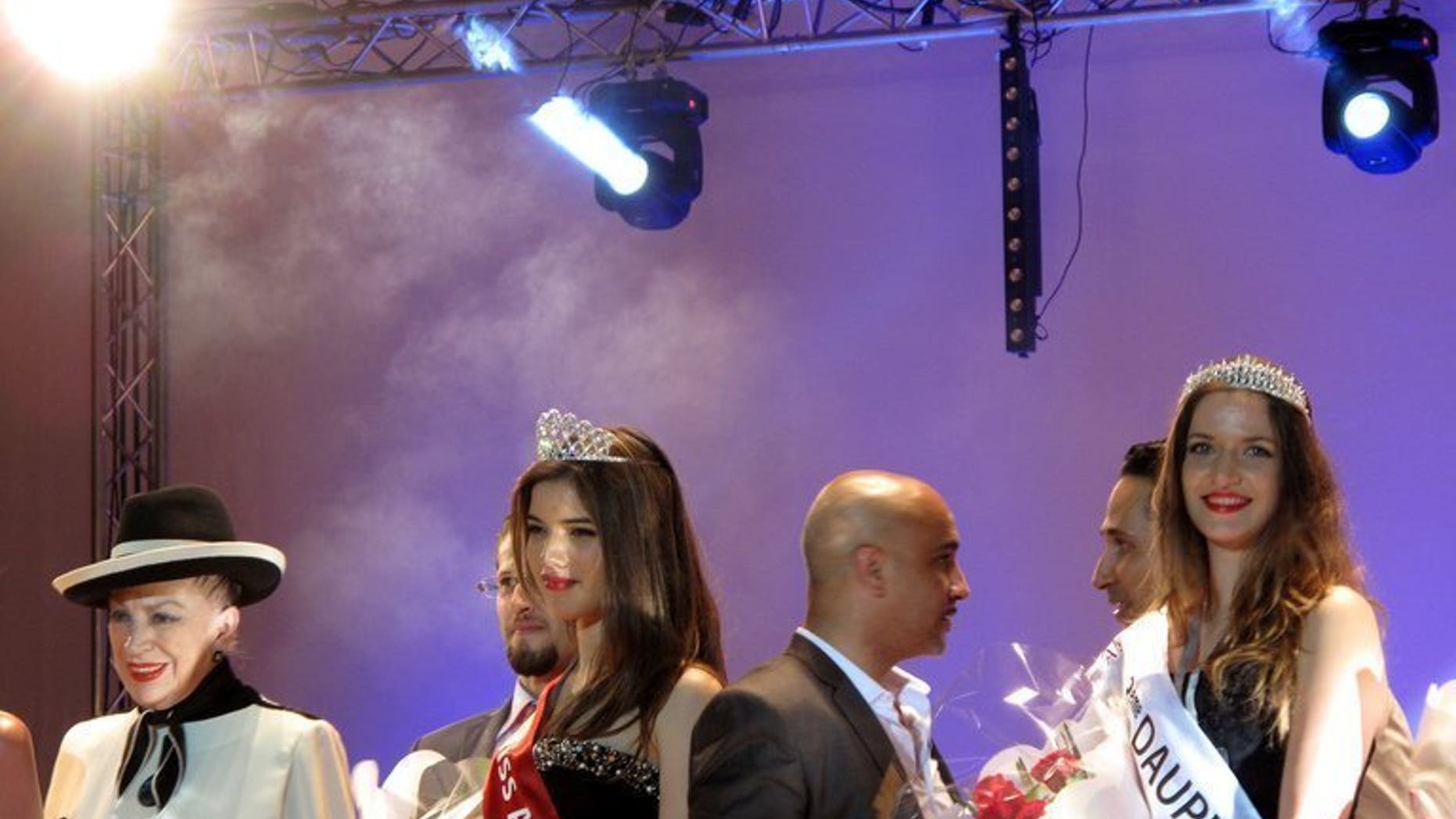 Rym Amari, Miss Algeria 2013, (C) stands with French beauty contest organiser Genevieve de Fontenay (L) and one of the runners-up at the end of the beauty pageant in the western city of Oran late on June 21, 2013. After an absence of 10 years, the Miss Algeria beauty contest was held in Oran, with 19-year-old science student Rym Amari taking the pageant honours.