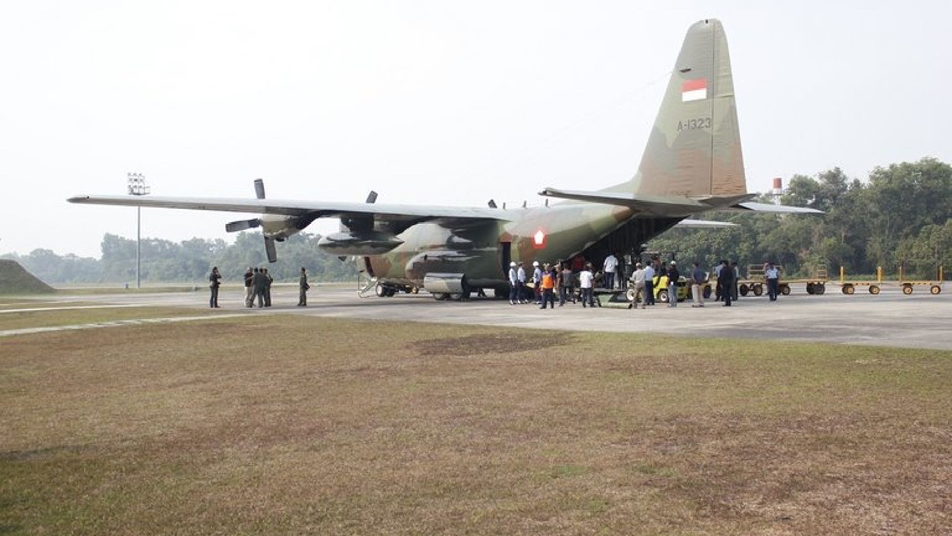 Soldiers and government personnel unload sacks of salt from an Indonesian Air Force Hercules, in Sumatra, on June 22, 2013. It was in preparation for a mission seeding clouds in an attempt to create rain to extinguish raging fires that have cloaked neighbouring Singapore and Malaysia in choking smog.