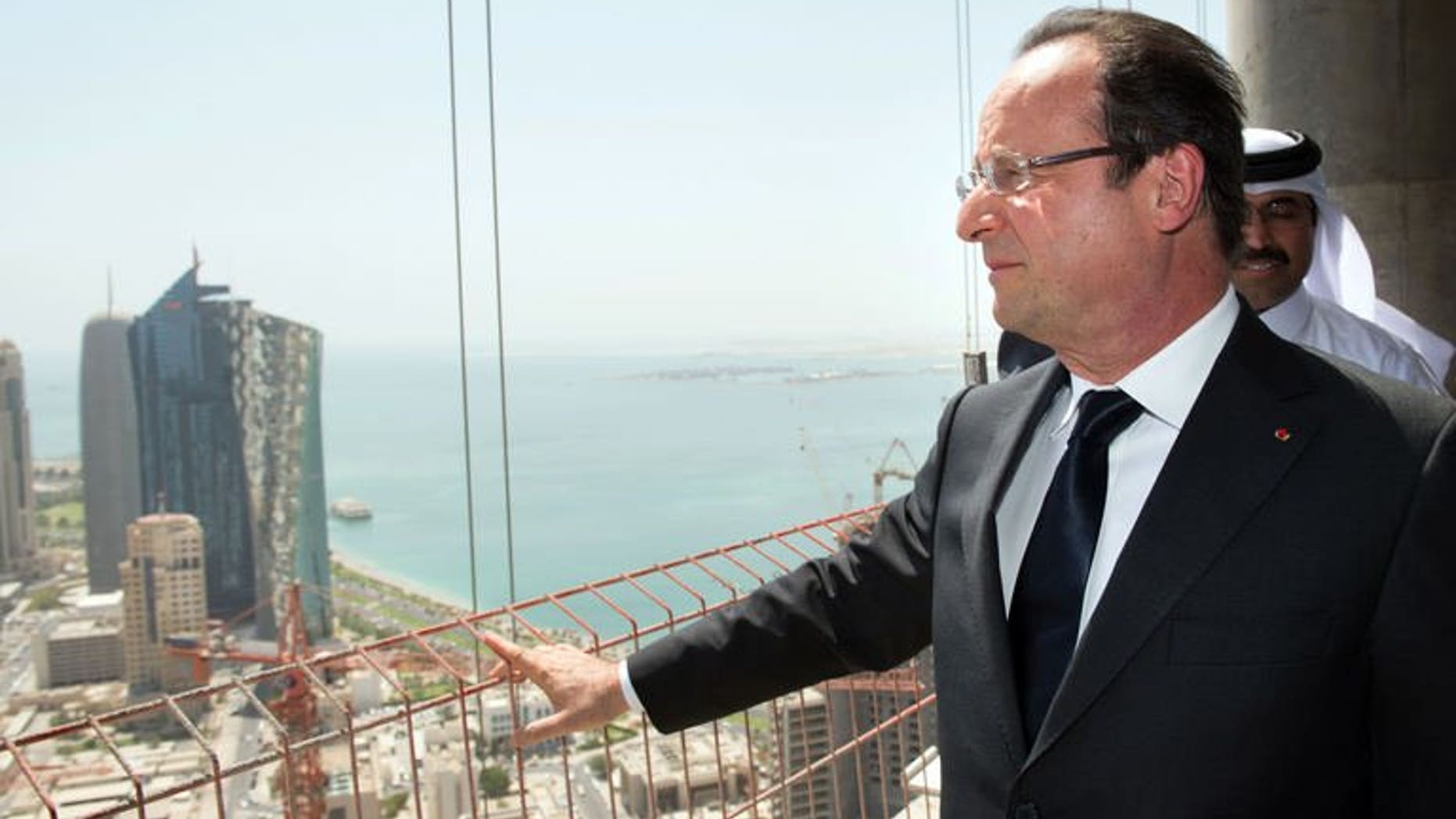 French President Francois Hollande visits a Bouygues construction site in the Qatari capital Doha, on June 23, 2013. Hollande is on a two-day official visit to Qatar for talks on the Syrian civil war and on economic ties with the gas-rich Gulf state. Hollande says he has "every reason to believe that eight Europeann hostages are alive", and that Paris was "always seeking contacts" to free them.