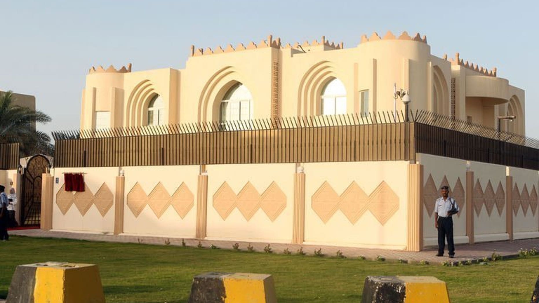 Security guards stand outside the new Taliban political office in Doha before the official opening, on June 18, 2013. The United States has warned it could call on the Taliban to close an office in Qatar unless it shows more commitment to reconciliation in Afghanistan.