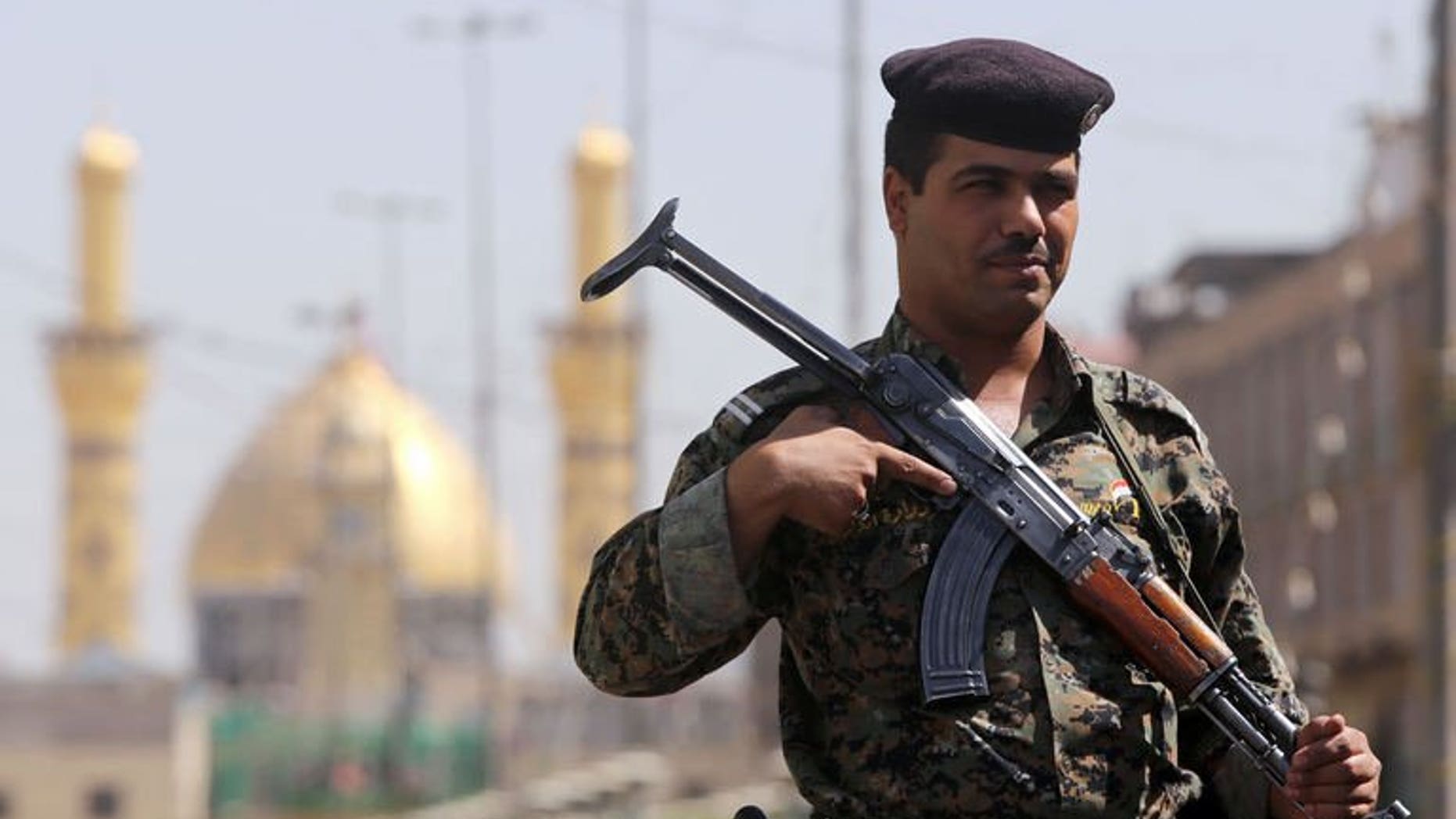 An Iraqi policeman stands guard outside the shrine of Imam Abbas as Shiite Muslims gather for the annual festival of Shaabaniya in the central city of Karbala, on June 23, 2013. Three car bombs, including a suicide attack, have killed at least four people in disputed territory in northern Iraq where analysts fear tensions could trigger a full-blown conflict.