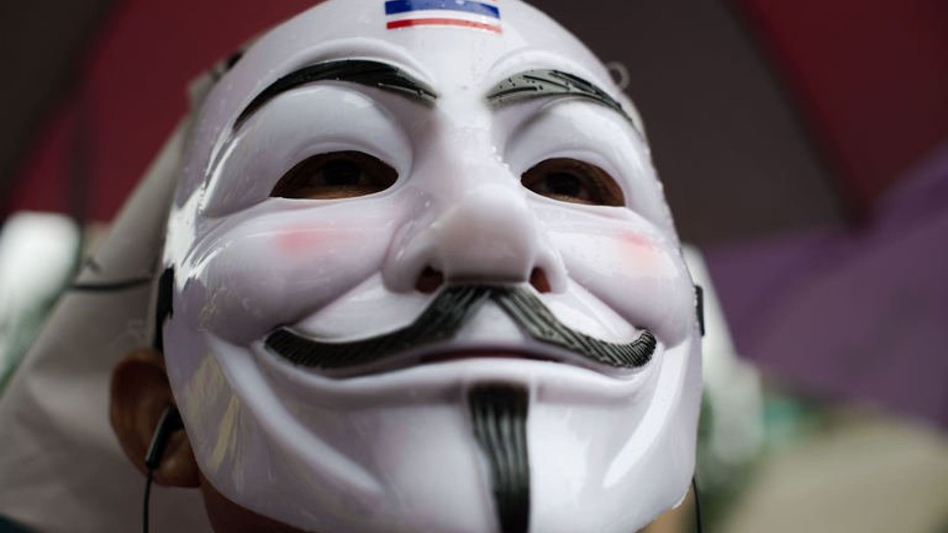 A protester wearing a Guy Fawkes mask attends a rally in Bangkok's shopping district on June 23, 2013. Hundreds of anti-government protesters -- many wearing Guy Fawkes masks -- converged in Bangkok, in a reminder of the kingdom's political divisions.