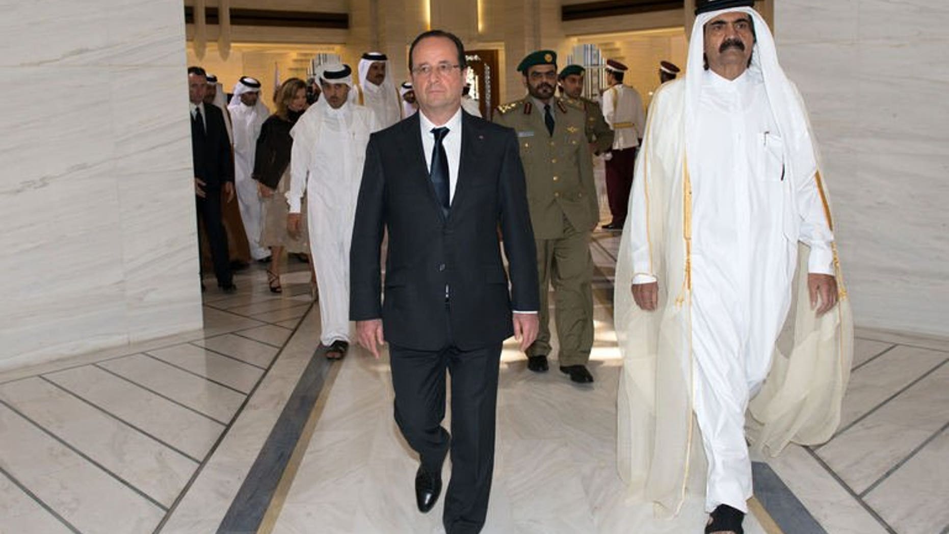 French President Francois Hollande (left) is greeted by Qatari Emir Sheikh Hamad bin Khalifa al-Thani at the Emiri Diwan in Doha, on June 23, 2013. Hollande has urged rebels in Syria to "retake" zones that have fallen into the hands of extremist Islamist groups.