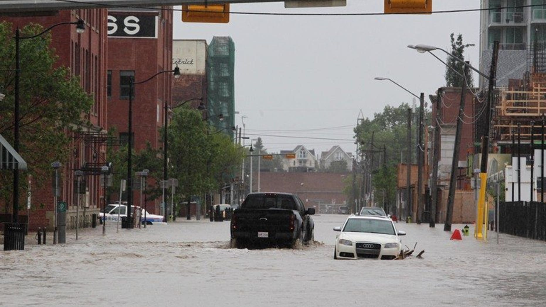 Downtown Calgary stands flooded with rising waters from torrential rain and swollen rivers in Alberta, Canada, on June 21, 2013. Canadian authorities in the western city of Medicine Hat ordered Sunday the evacuation of buildings in low-lying areas a day after flooding killed three people and forced 100,000 to leave Calgary.