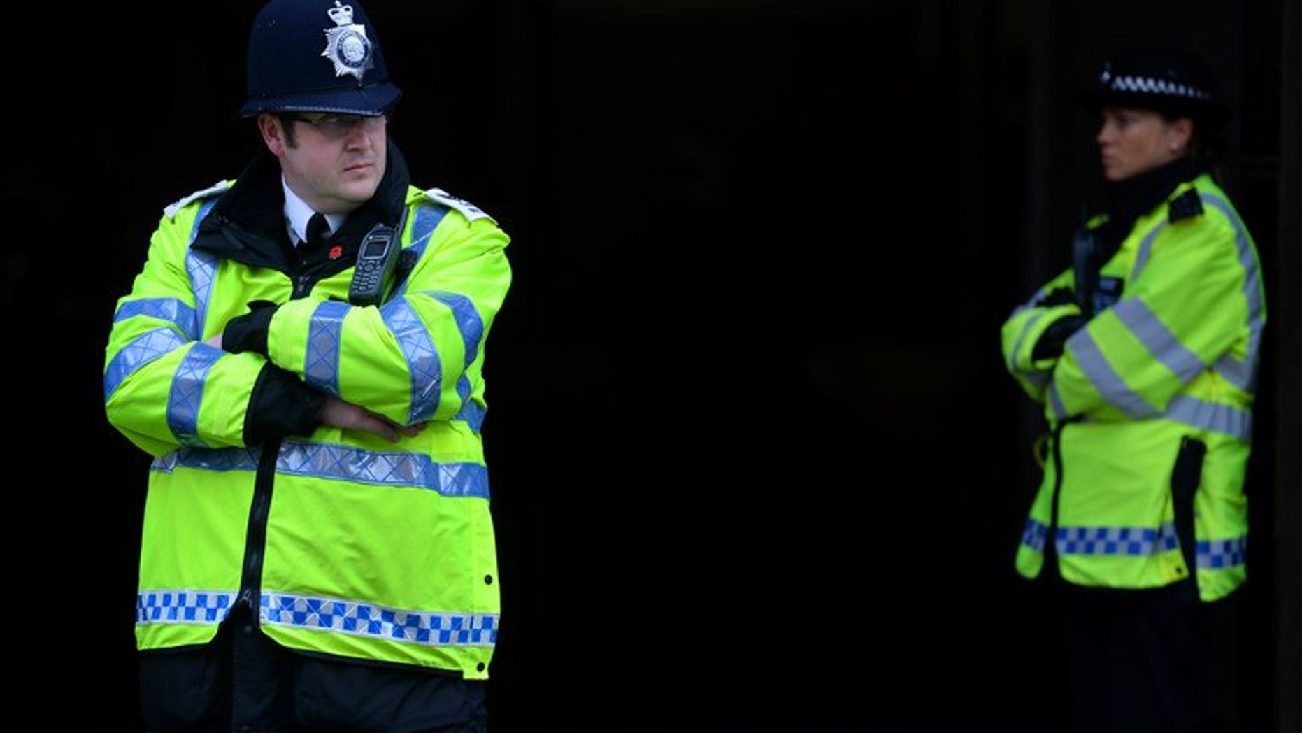 British police officers stand in position at Westminster Magistrates court in central London on May 30, 2013. British police on Sunday said that a suspicious item found outside a mosque in central England, which led to 150 local residents being evacuated, was a small home-made explosive device.