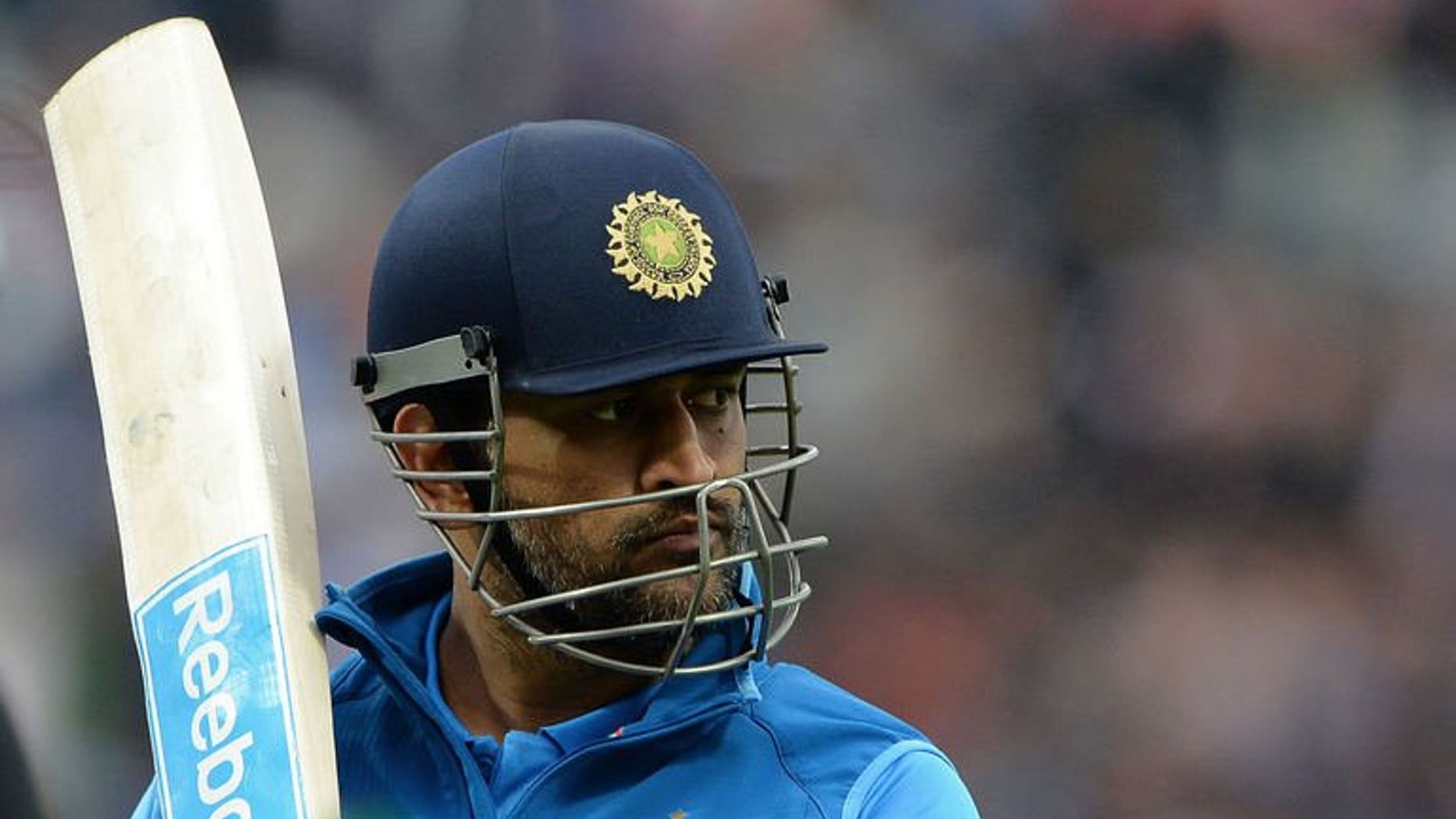 Indian captain Mahendra Sing Dhoni leaves the field after losing his wicket during the 2013 ICC Champions Trophy Final cricket match between England and India at Edgbaston in Birmingham, central England on June 23, 2013. Dhoni praised the mental resilience of his side after they beat England by just five runs in a thrilling Champions Trophy final at Edgbaston on Sunday.