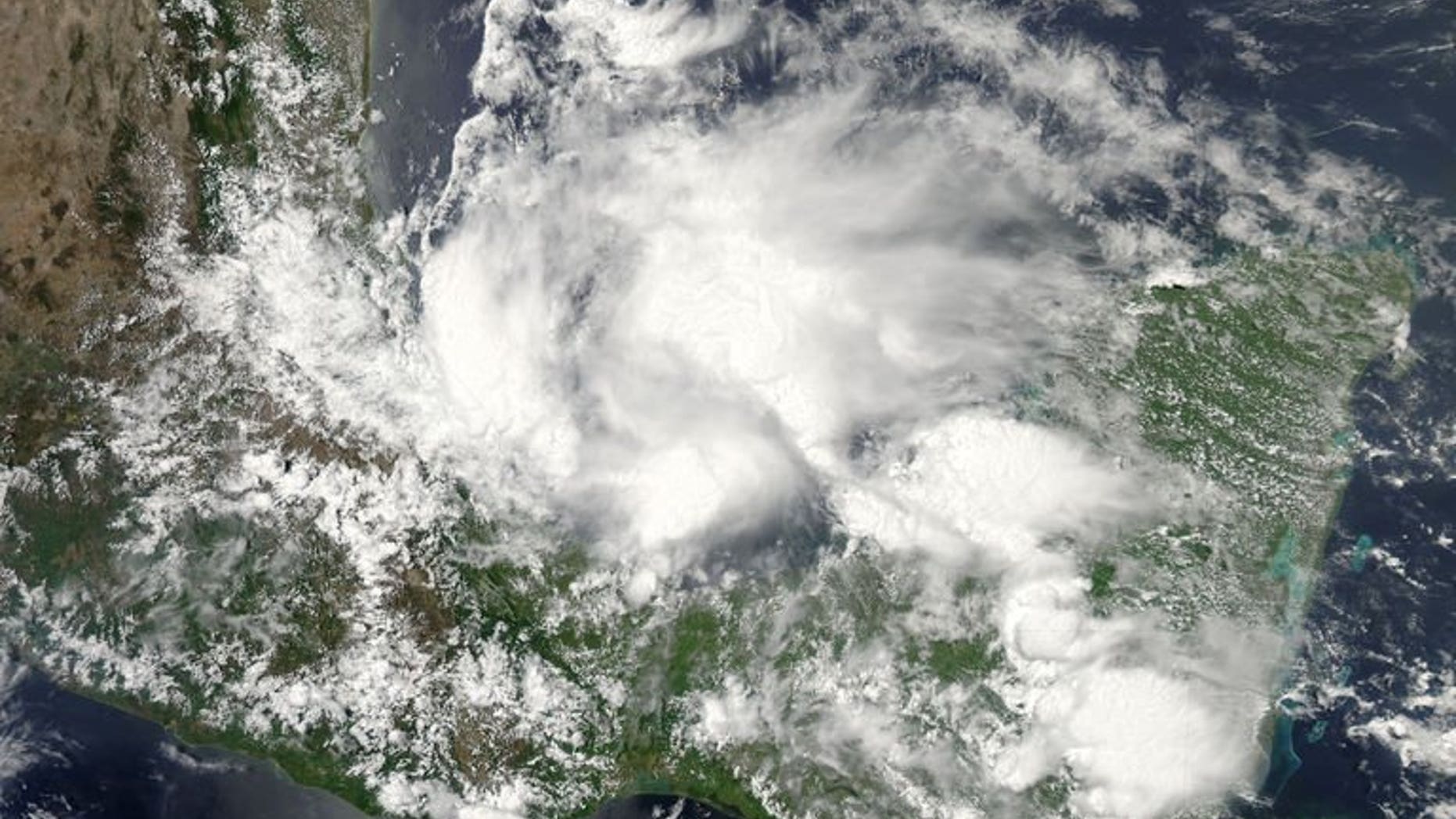 This June 19, 2013 NASA satellite image shows Tropical Storm Barry. An eight-year-old child and his mother were killed in southern Mexico after being swept away in a river during the storm, bringing the death toll to three.
