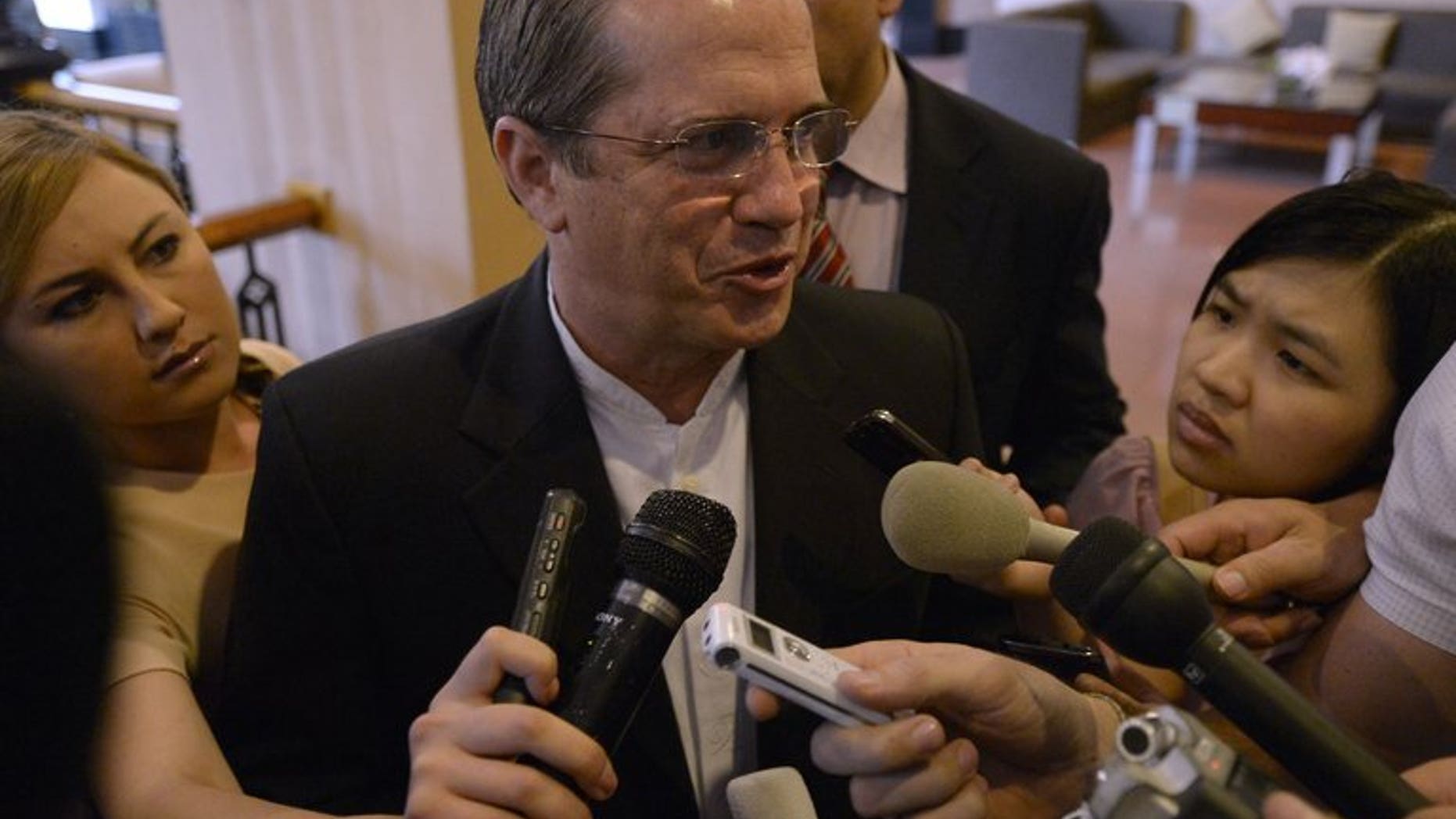 Visiting Ecuador Foreign Minister Ricardo Patino talks to reporters as he leaves a hotel in Hanoi on June 24, 2013. He said his country was "analysing" a request for asylum by fugitive US intelligence leaker Edward Snowden who is currently in Moscow.