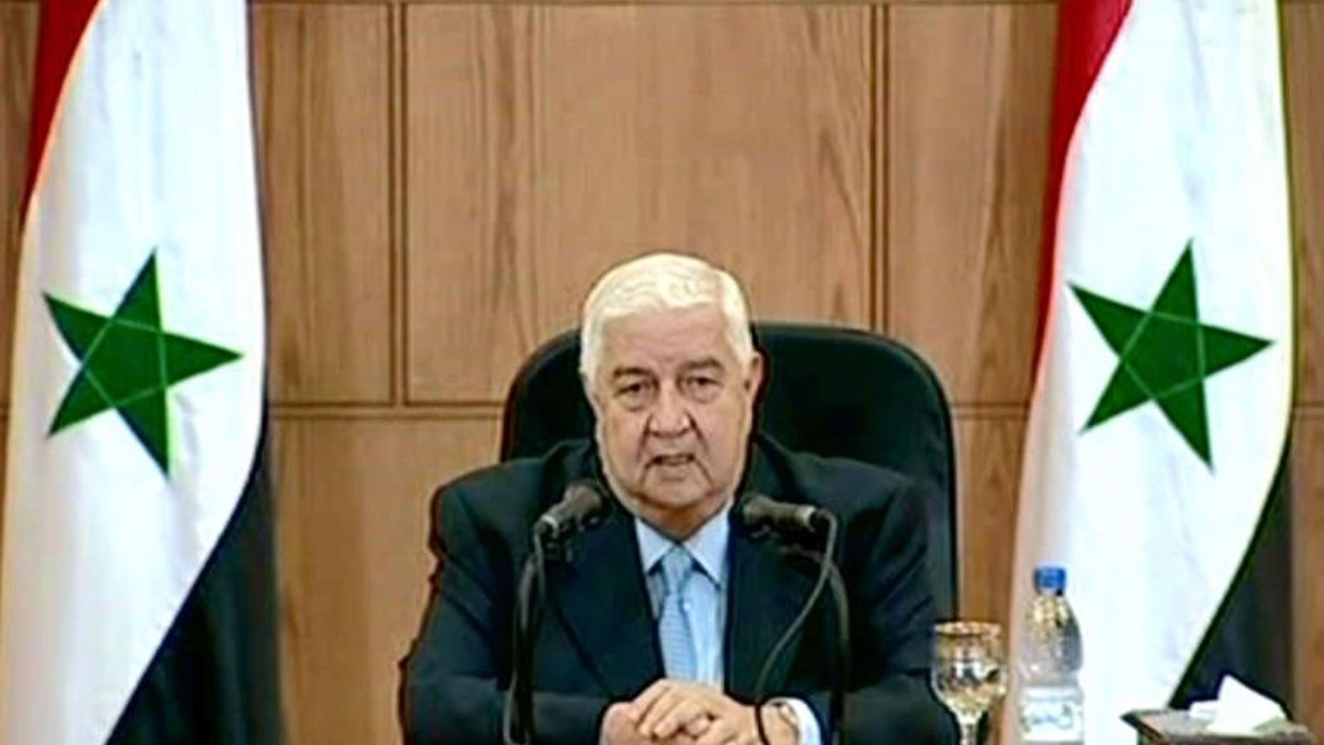 A handout picture released by the Syrian Arab News Agency (SANA) shows Syrian Foreign Minister Walid Muallem speaking during a televised press conference in Damascus, on June 24, 2013.