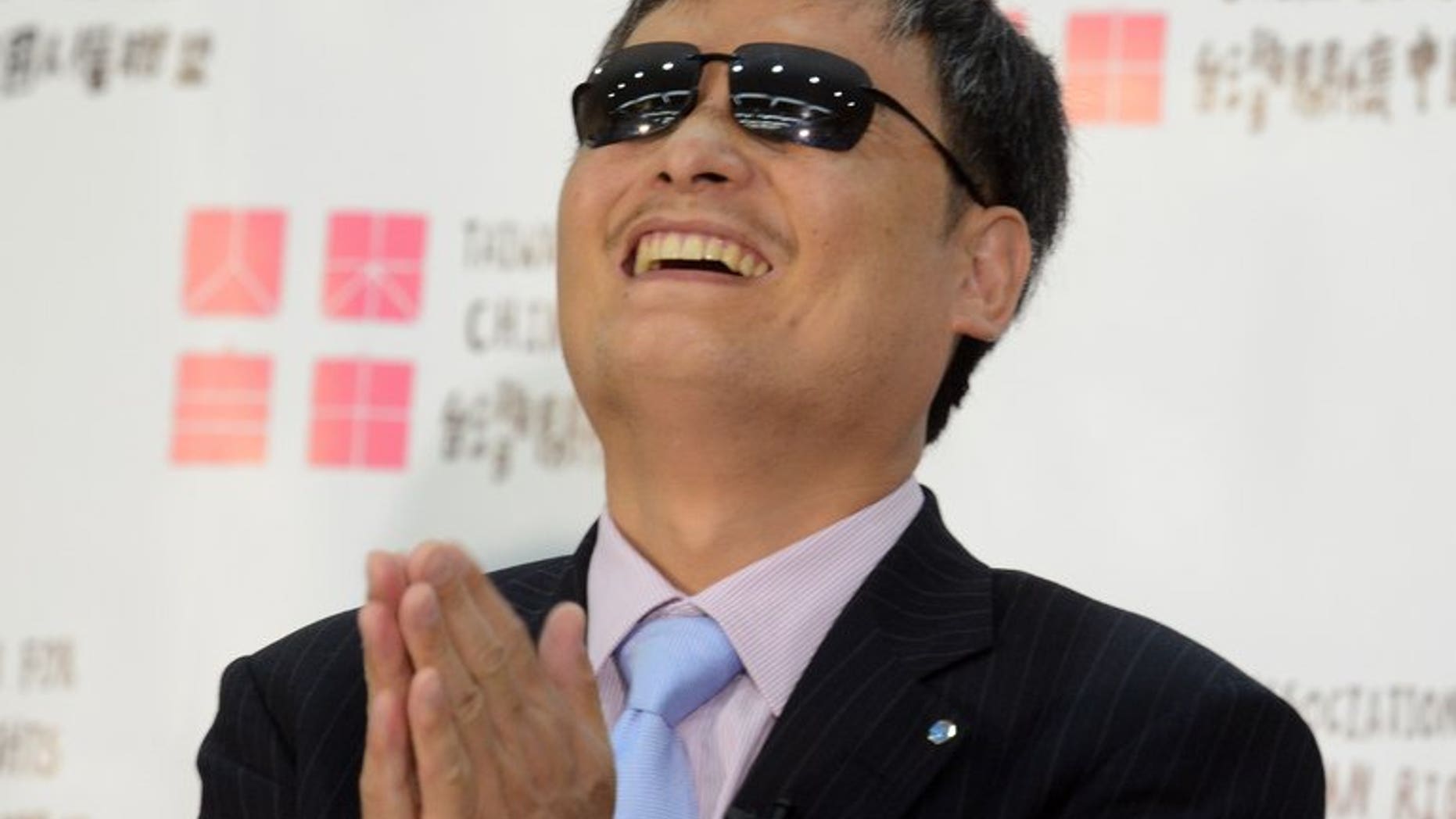 Chinese dissident Chen Guangcheng gestures during a press conference in Taipei, on June 24, 2013. Chen has urged Taiwan to stand up to China's "illegitimate" communist government, as he visited the self-governing island amid controversy over his future in the United States.
